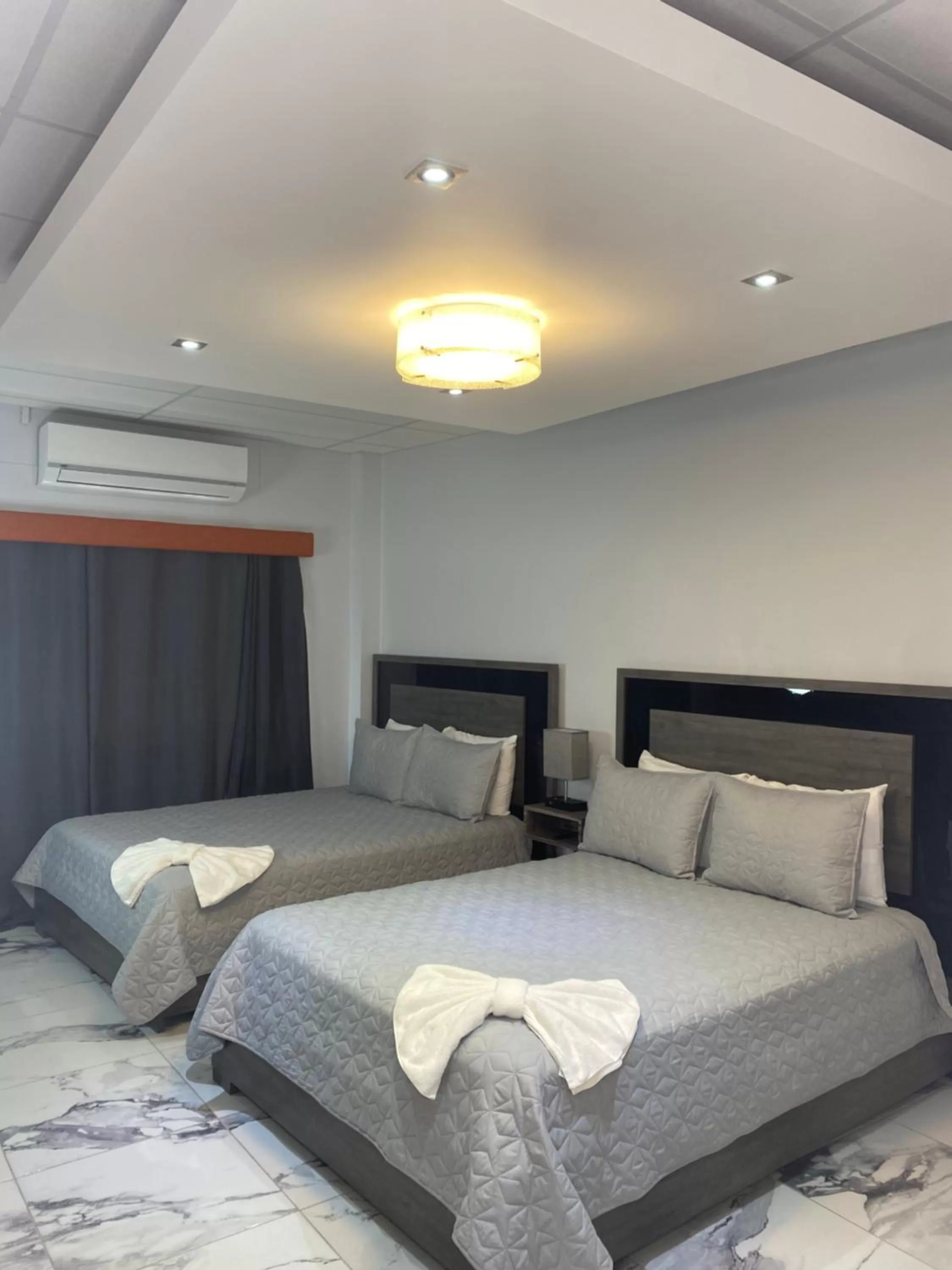 Bed in Itza-Bella Suites