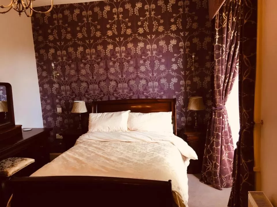 Bed in Brass Castle Country House Accommodation