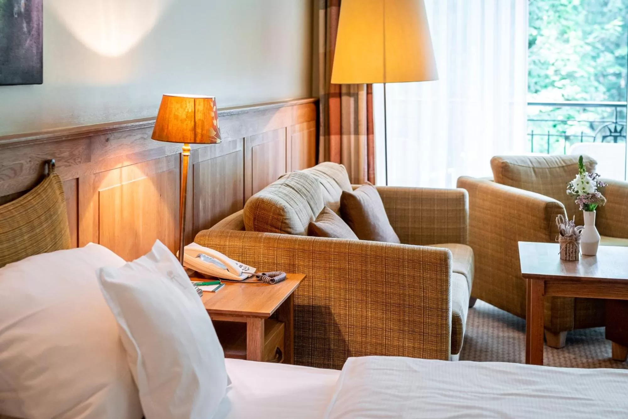 Seating area, Bed in Waldhotel Tannenhäuschen