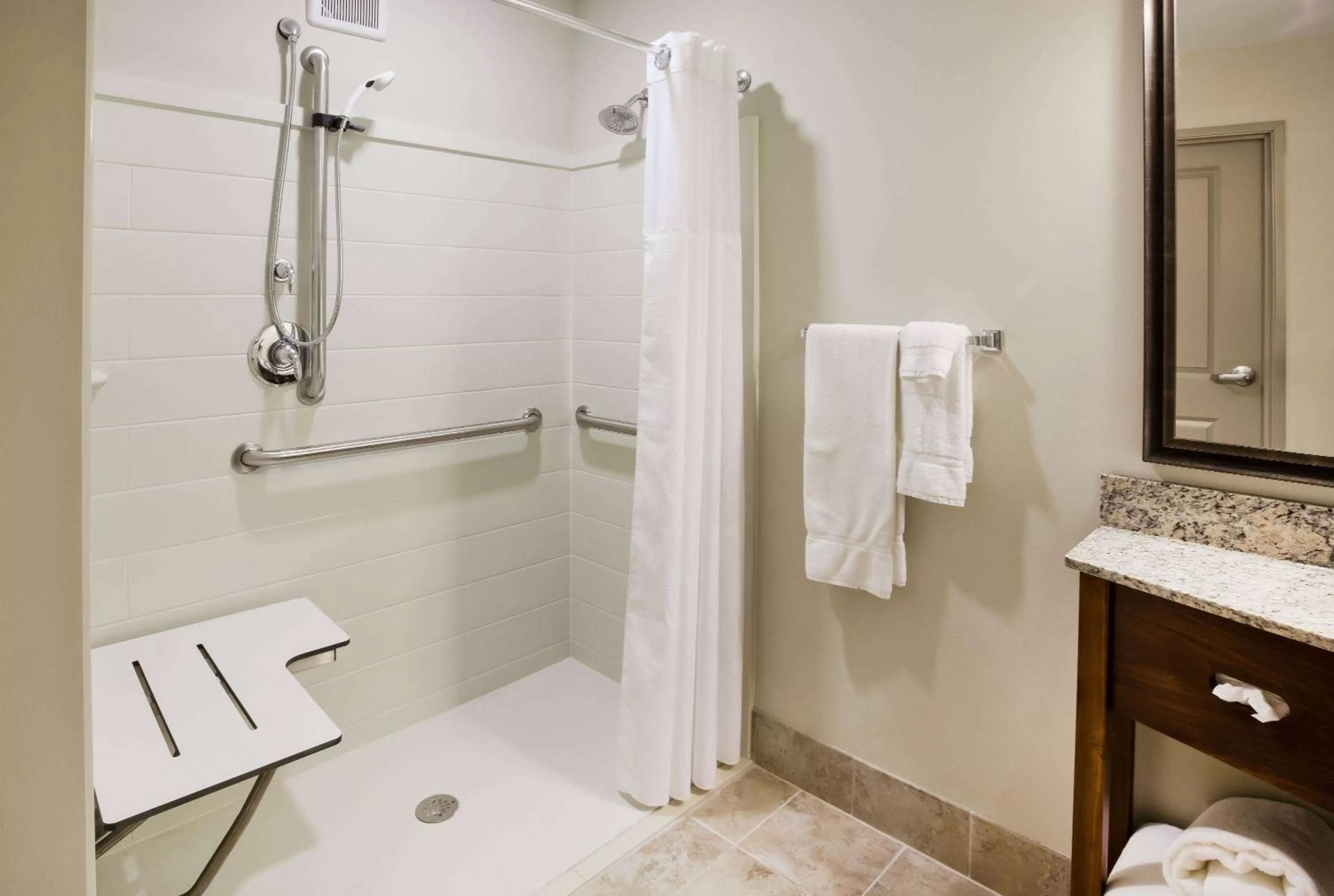 Shower in AmericInn by Wyndham DeWitt