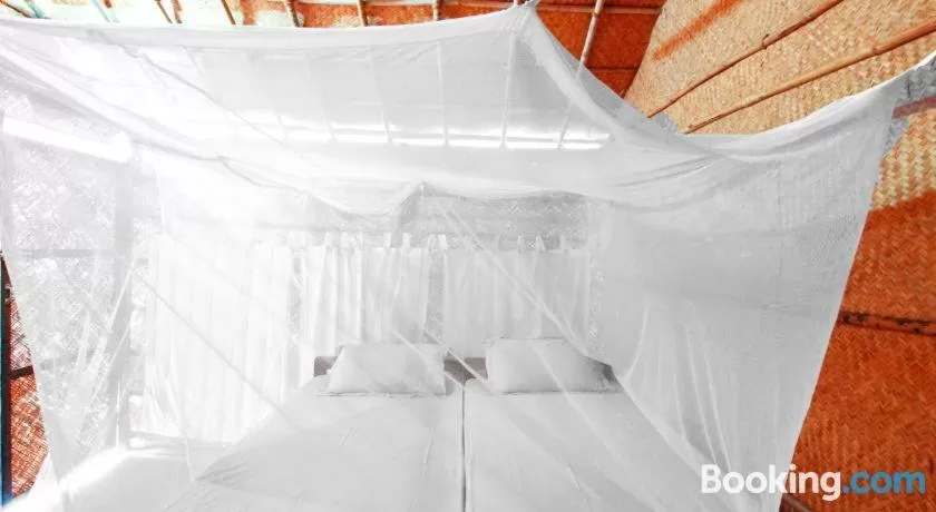 Bed in Blue Corner Beach Huts & Restaurant