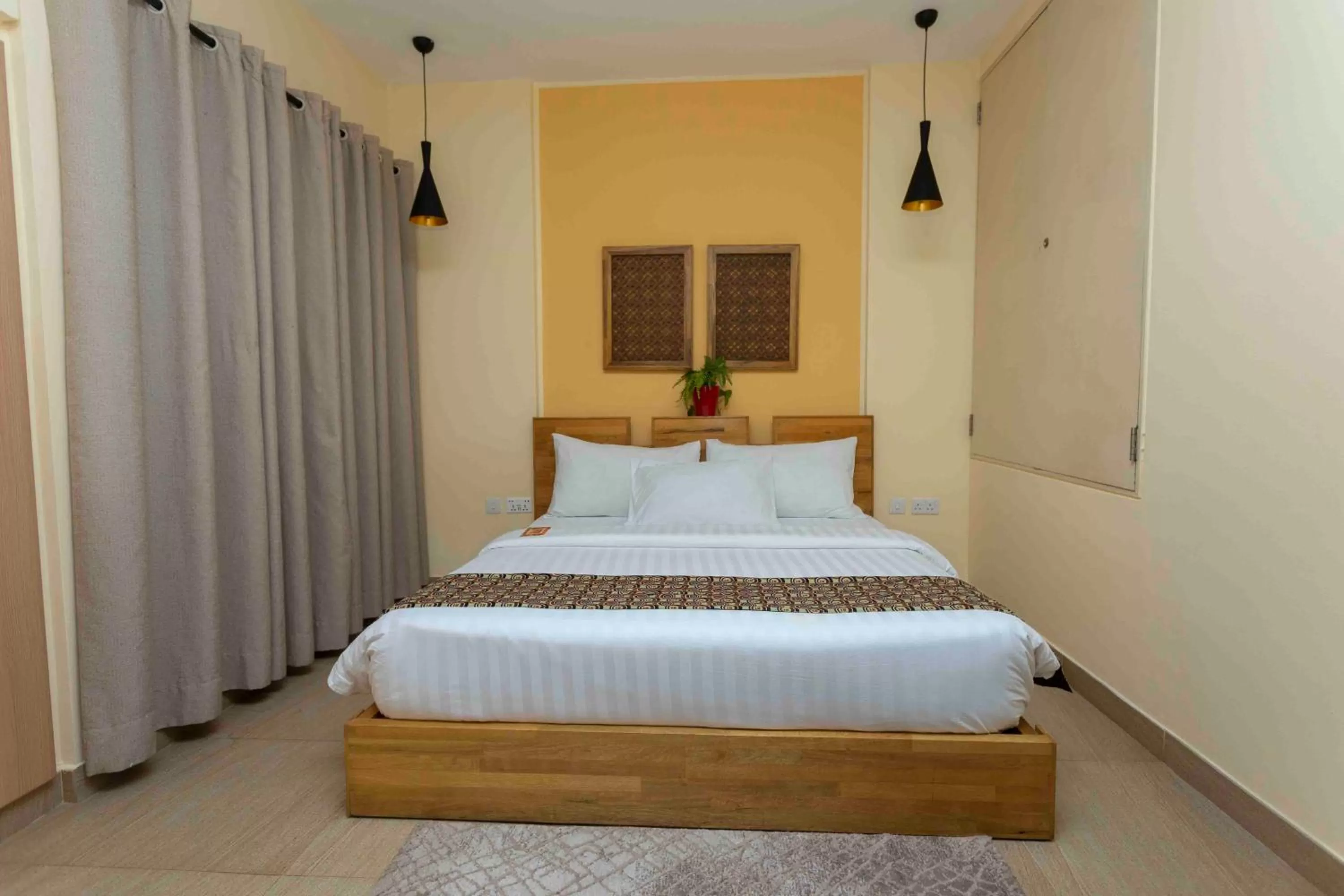 Bed in Roots Hotel Apartment