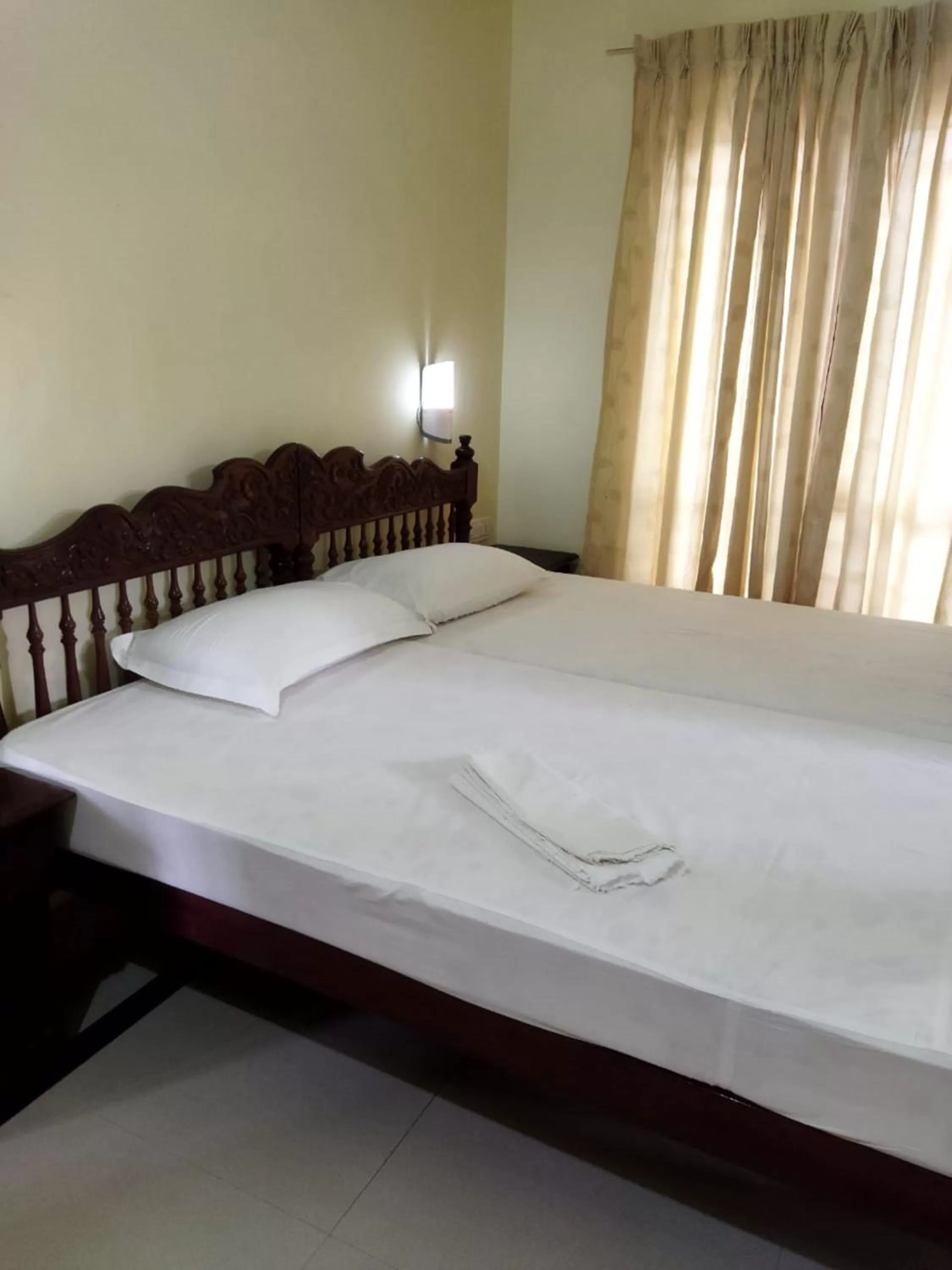 Bed in Sree Mookambika Beach Resort