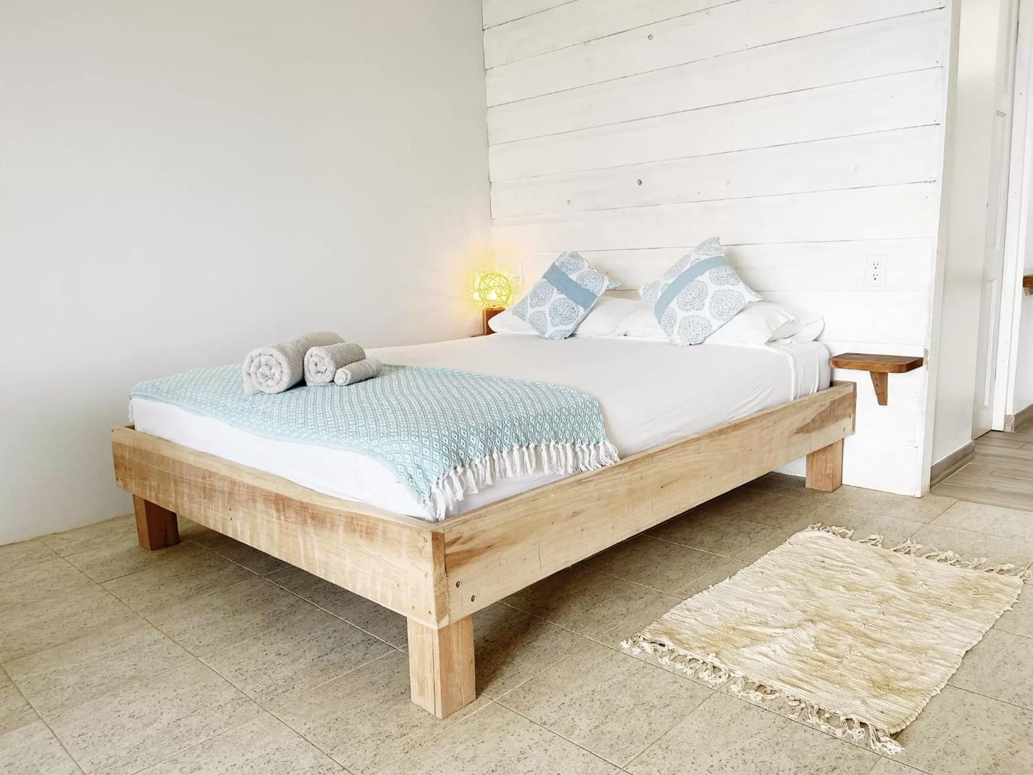 Bed in Bird Island Bungalows