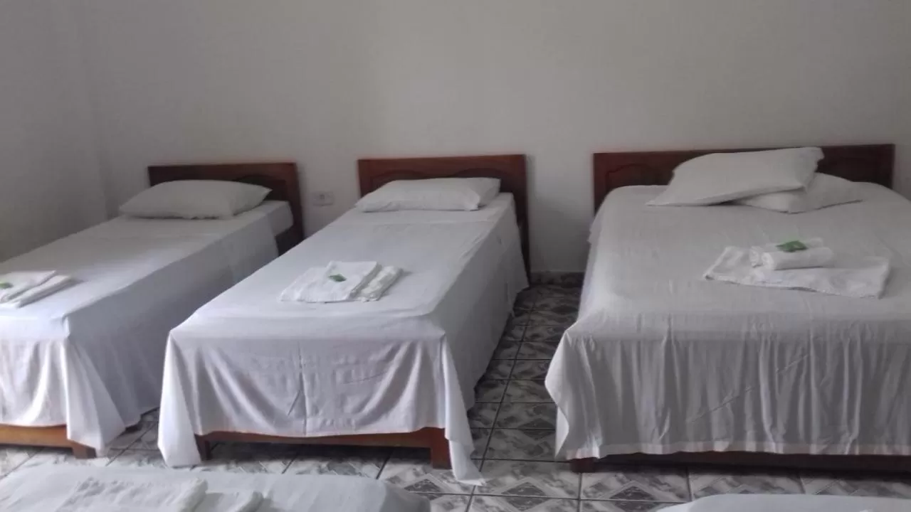 Bed in Pousada Oliveira