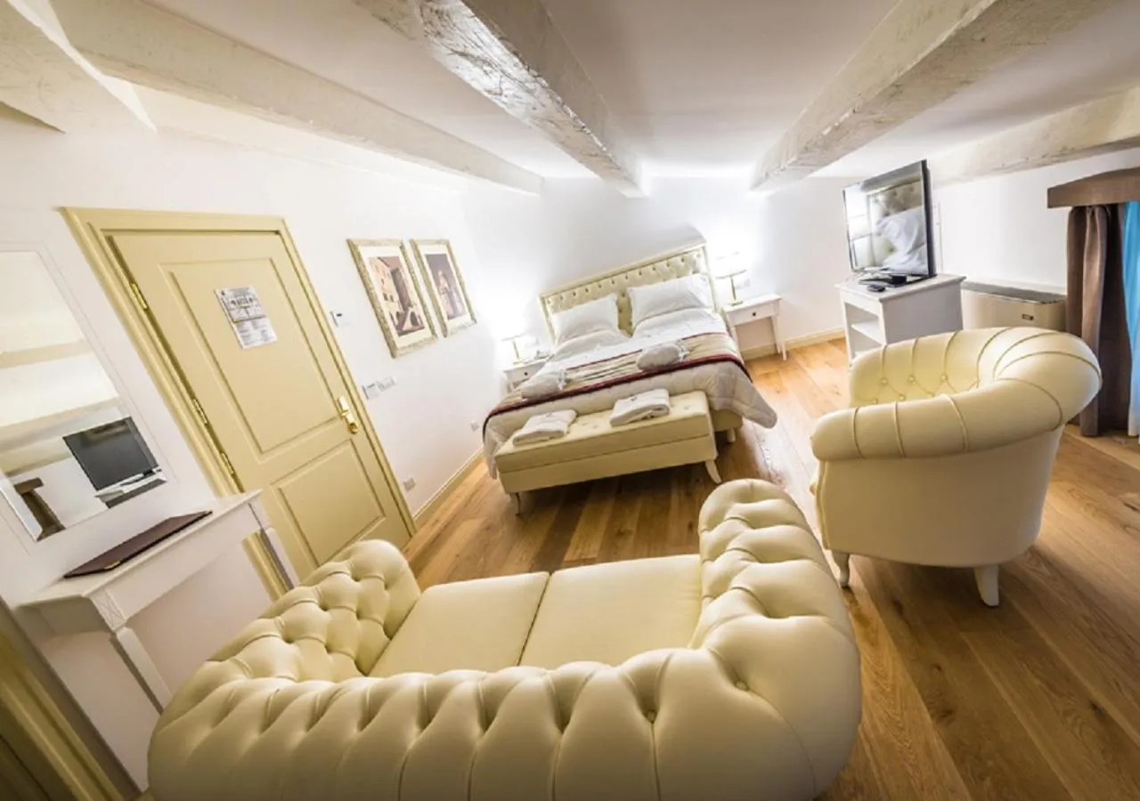 Seating area, Bed in Relais Paradiso Resort & Spa