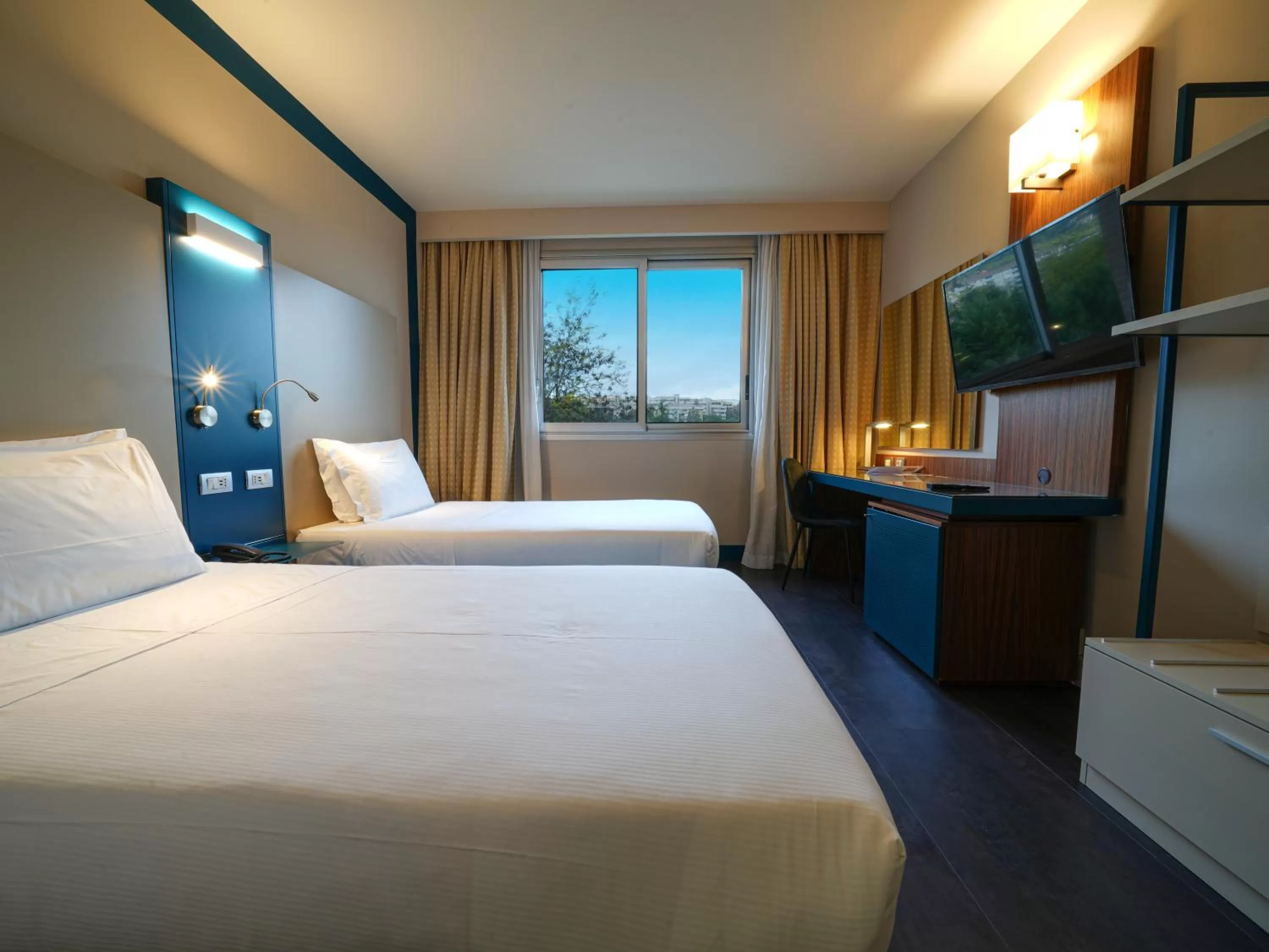 Bed in La Meridiana Bleisure Hotel