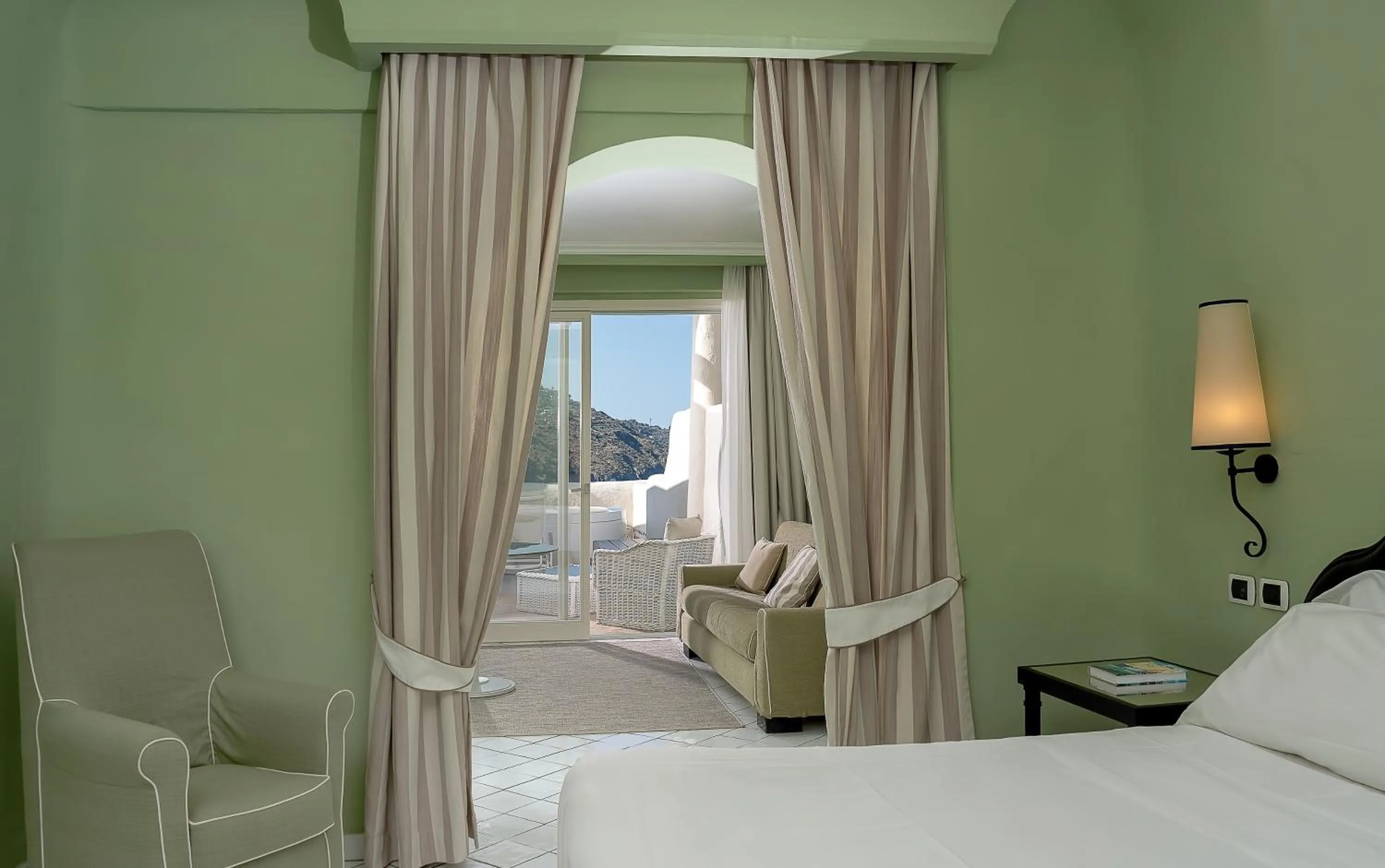 Living room, Bed in Therasia Resort Sea and SPA - The Leading Hotels of the World