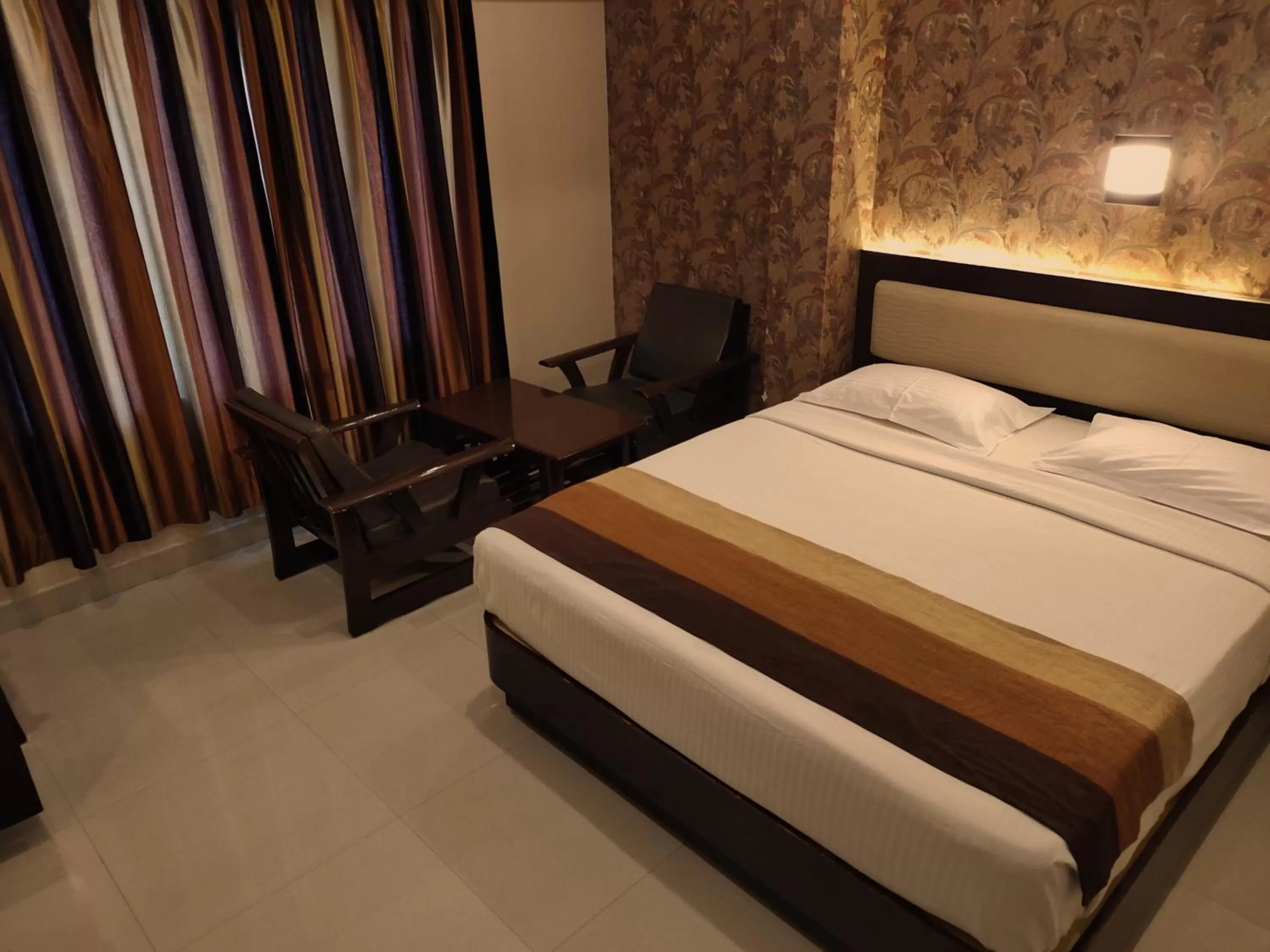 Seating area, Bed in Hotel Deepam