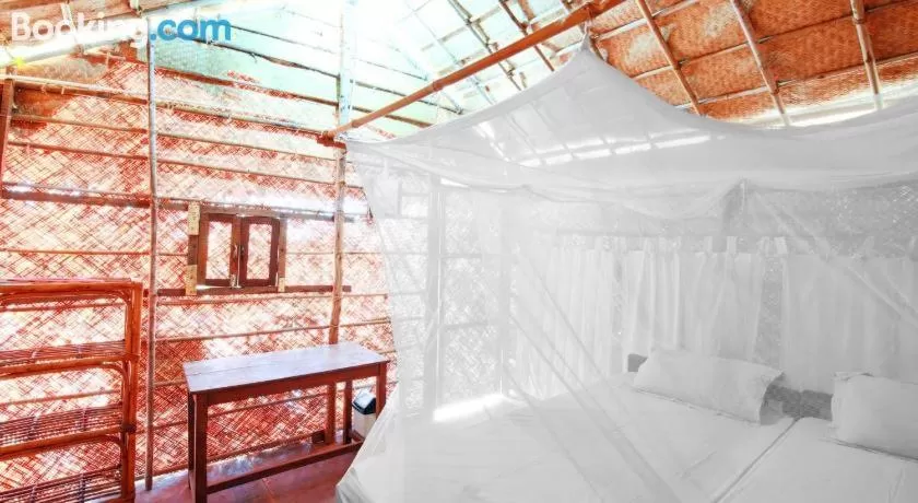 Bed in Blue Corner Beach Huts & Restaurant