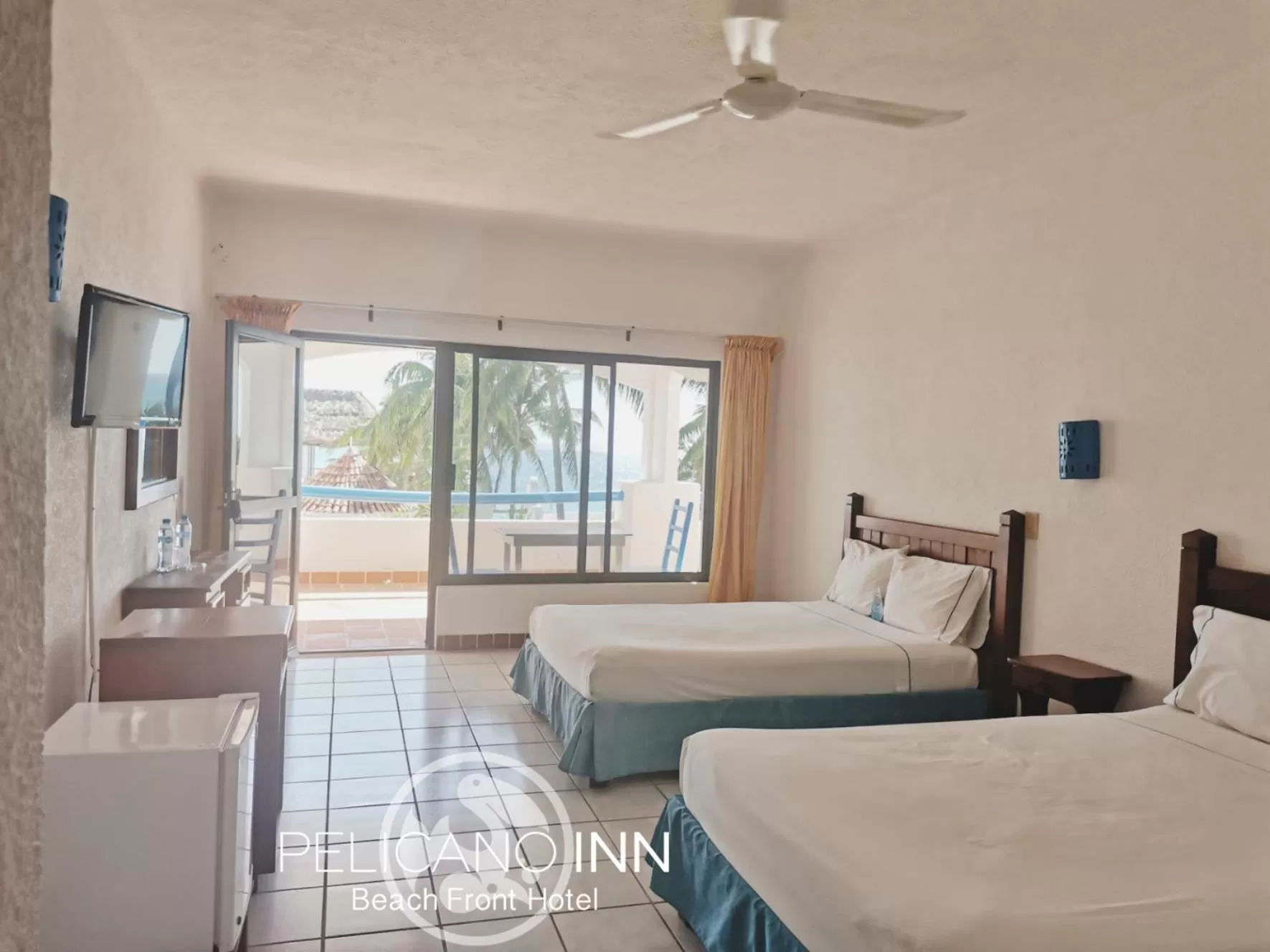 Photo of the whole room, Bed in Pelicano Inn Playa del Carmen - Beachfront Hotel