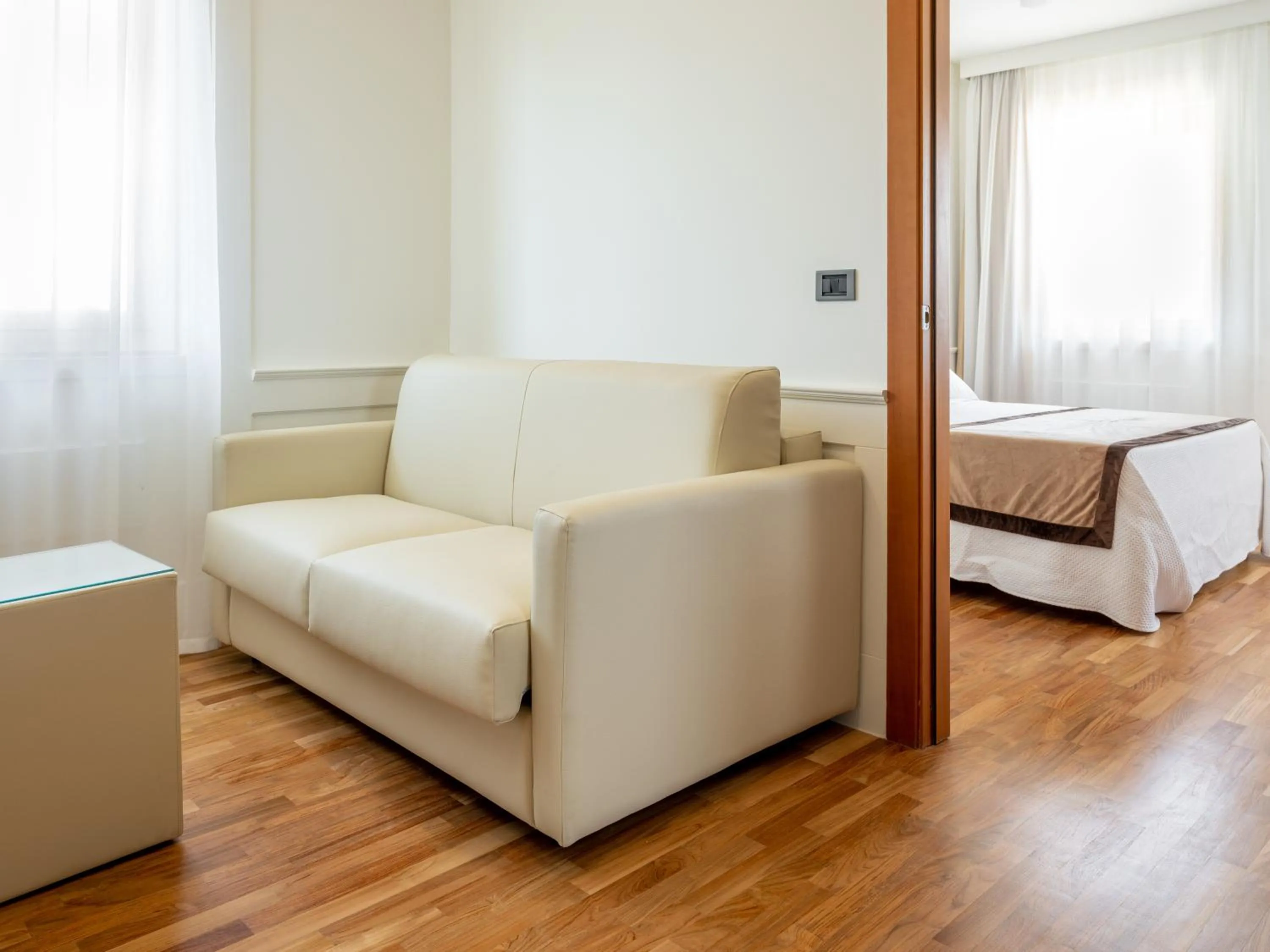 Seating area, Bed in Mirabella Hotel