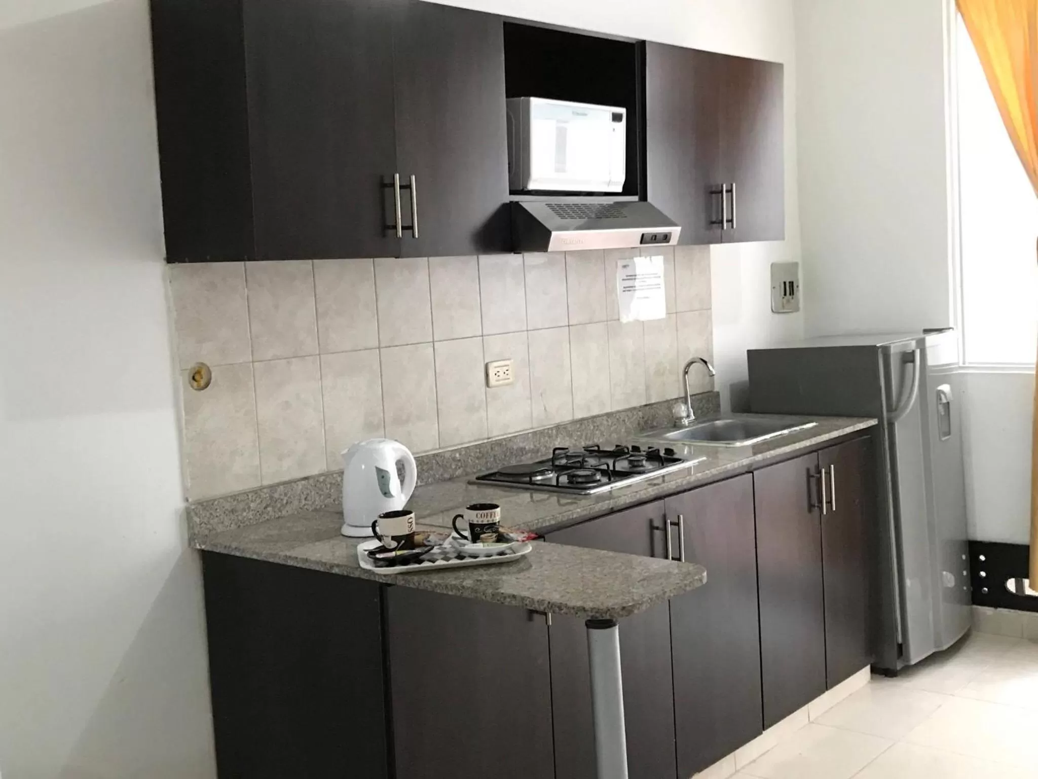 Kitchen or kitchenette in Arco Apartasuites