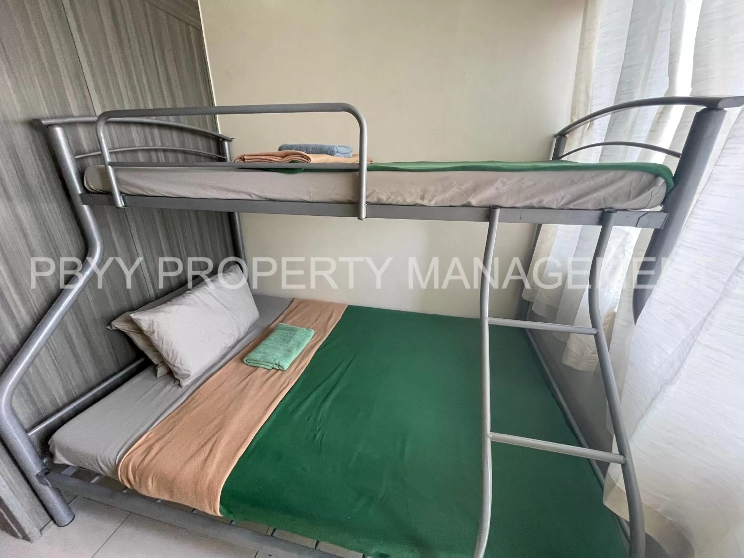 Bed in Green Residences Stays by PBYY