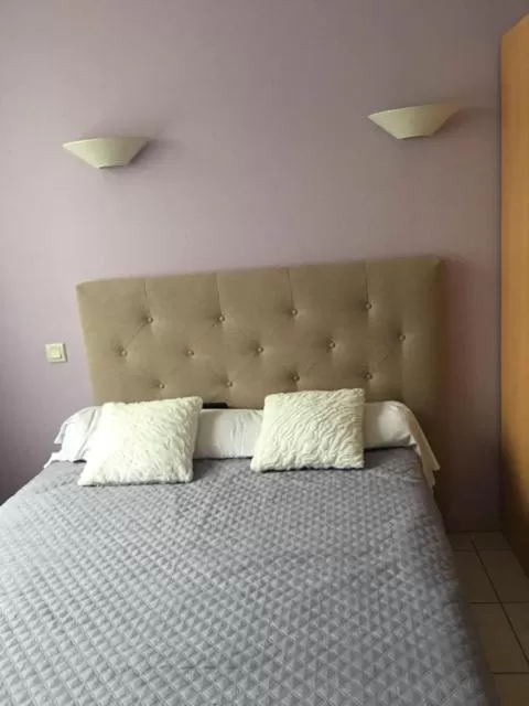 Bed in HOTEL DU CYGNE DE LA CROIX BLANCHE