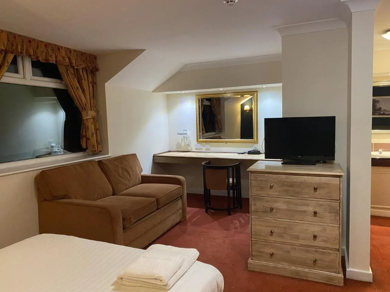 Communal lounge/ TV room in The Greyhound Hotel