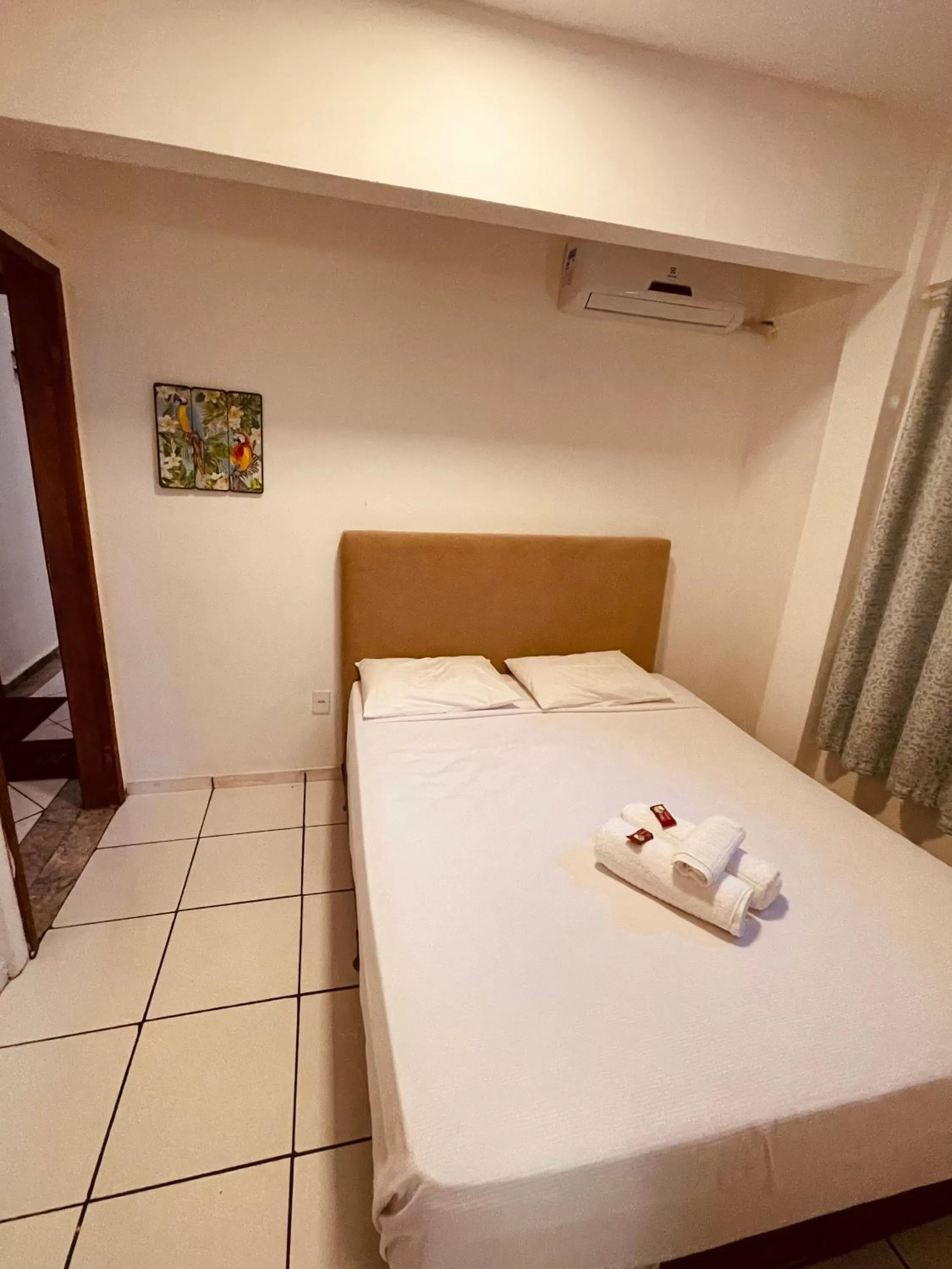 Bed in Flamingo Beach Pousada