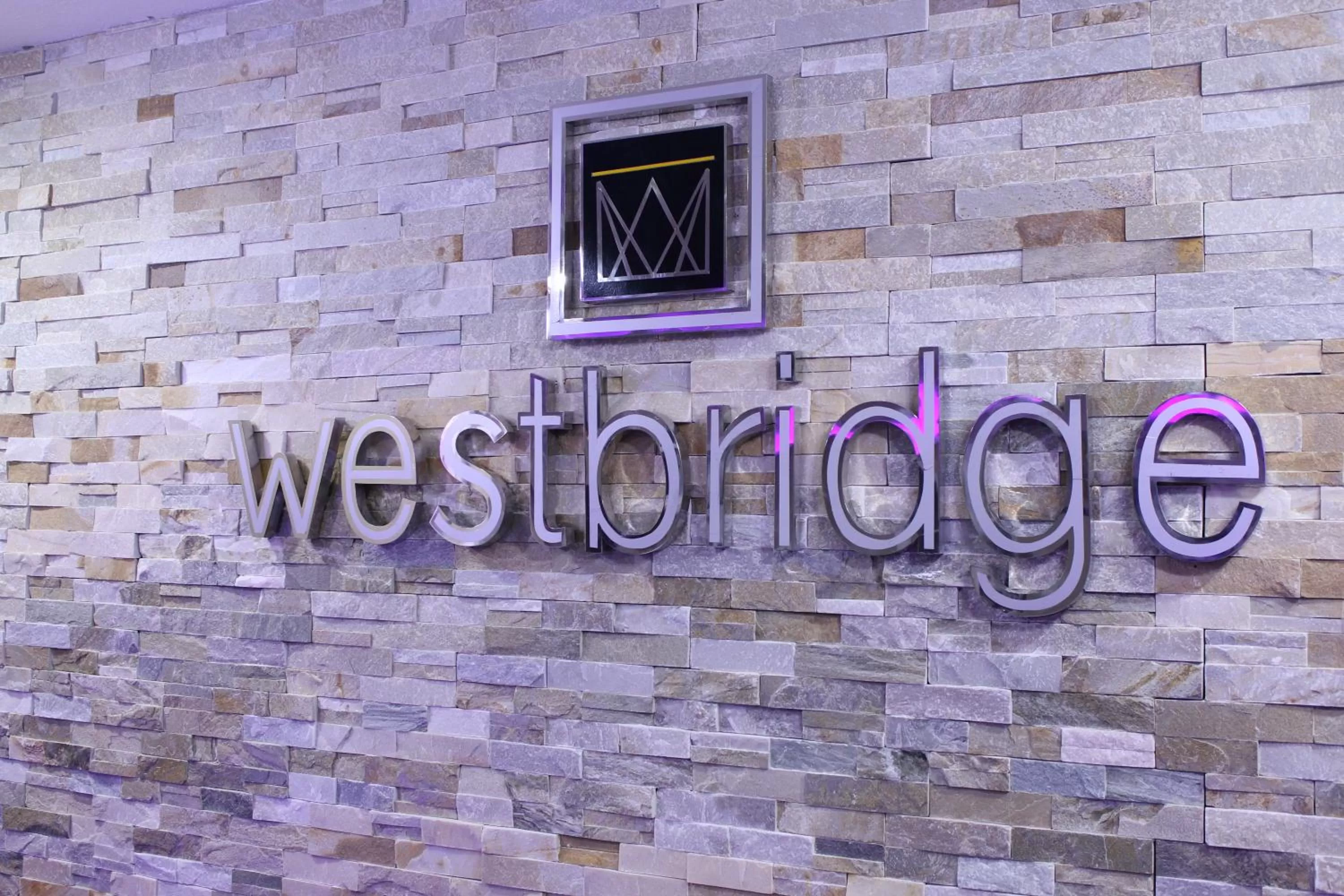 Property logo or sign in Westbridge Inn & Suites