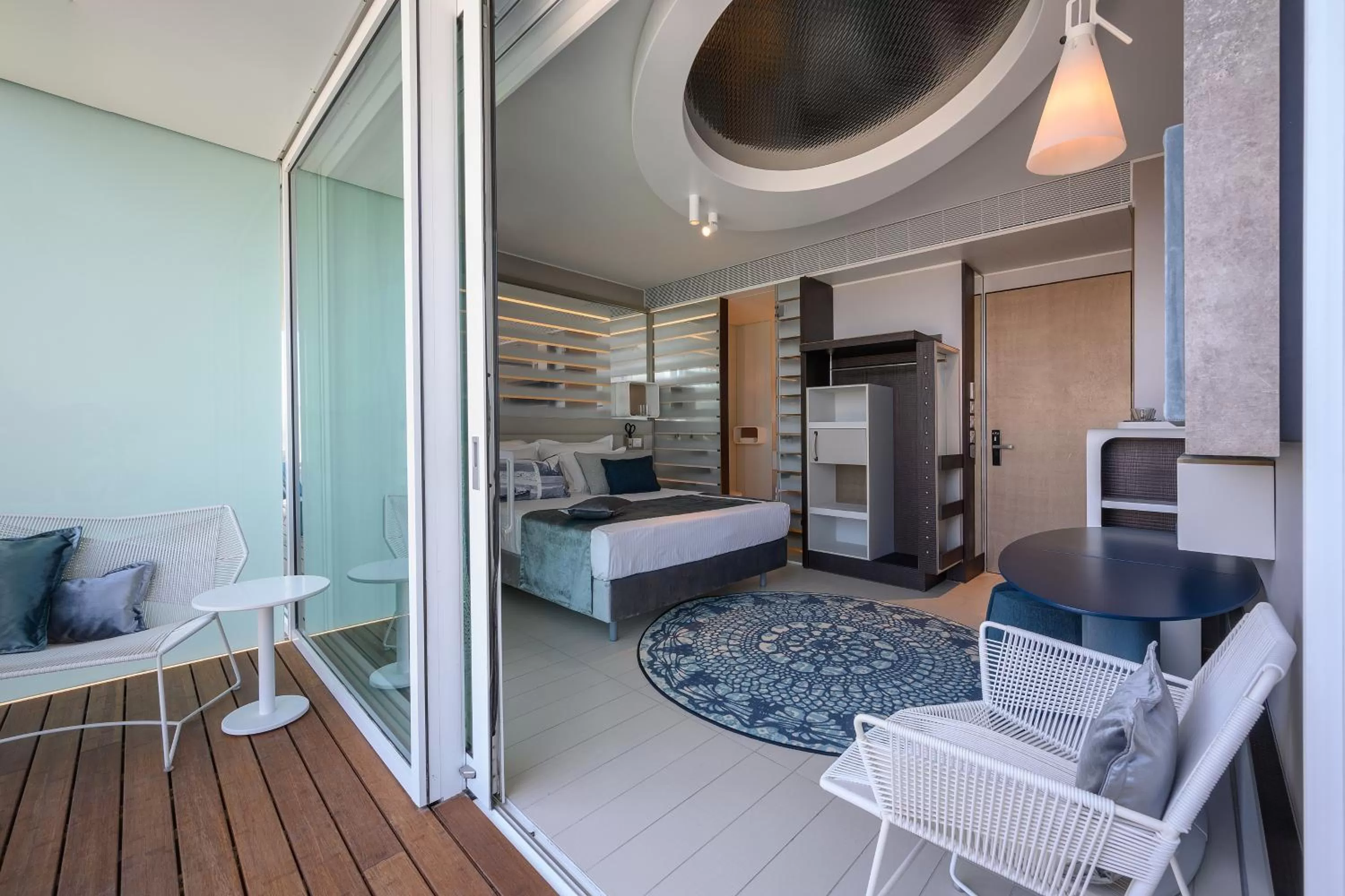 Seating area, Bed in Port Tower by Isrotel Design