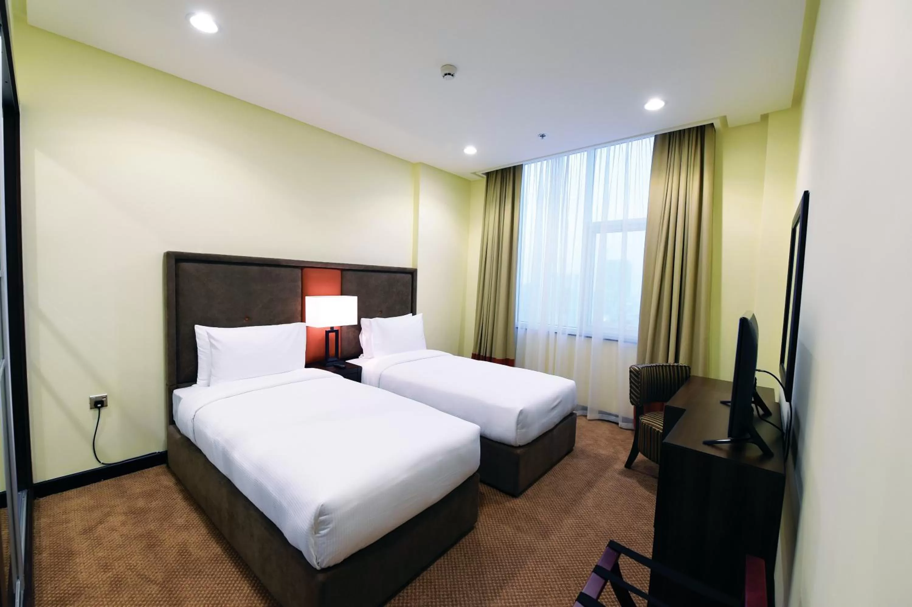 Bed in Orange Suites Hotel