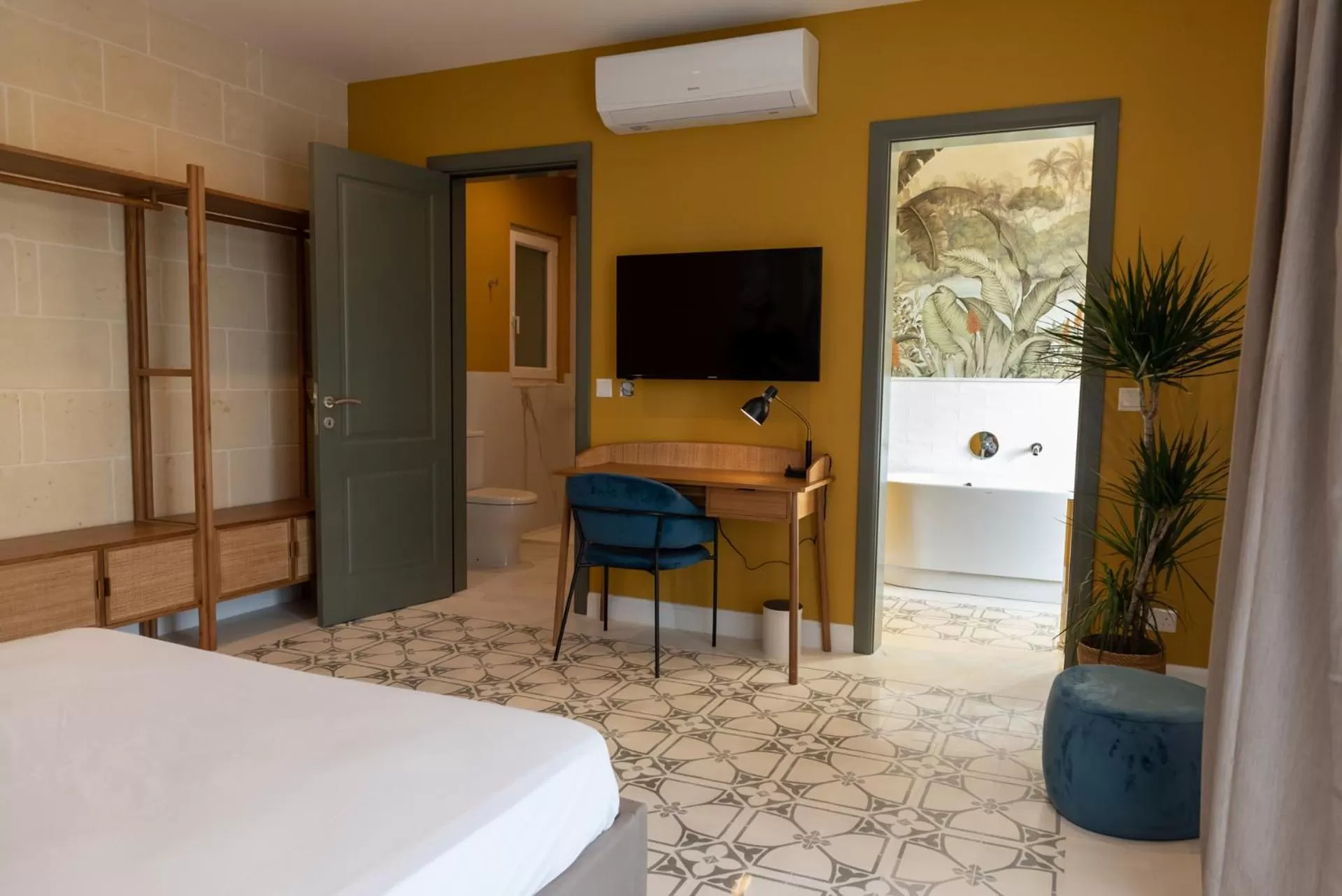 Toilet, TV/Entertainment Center in The Carob Tree