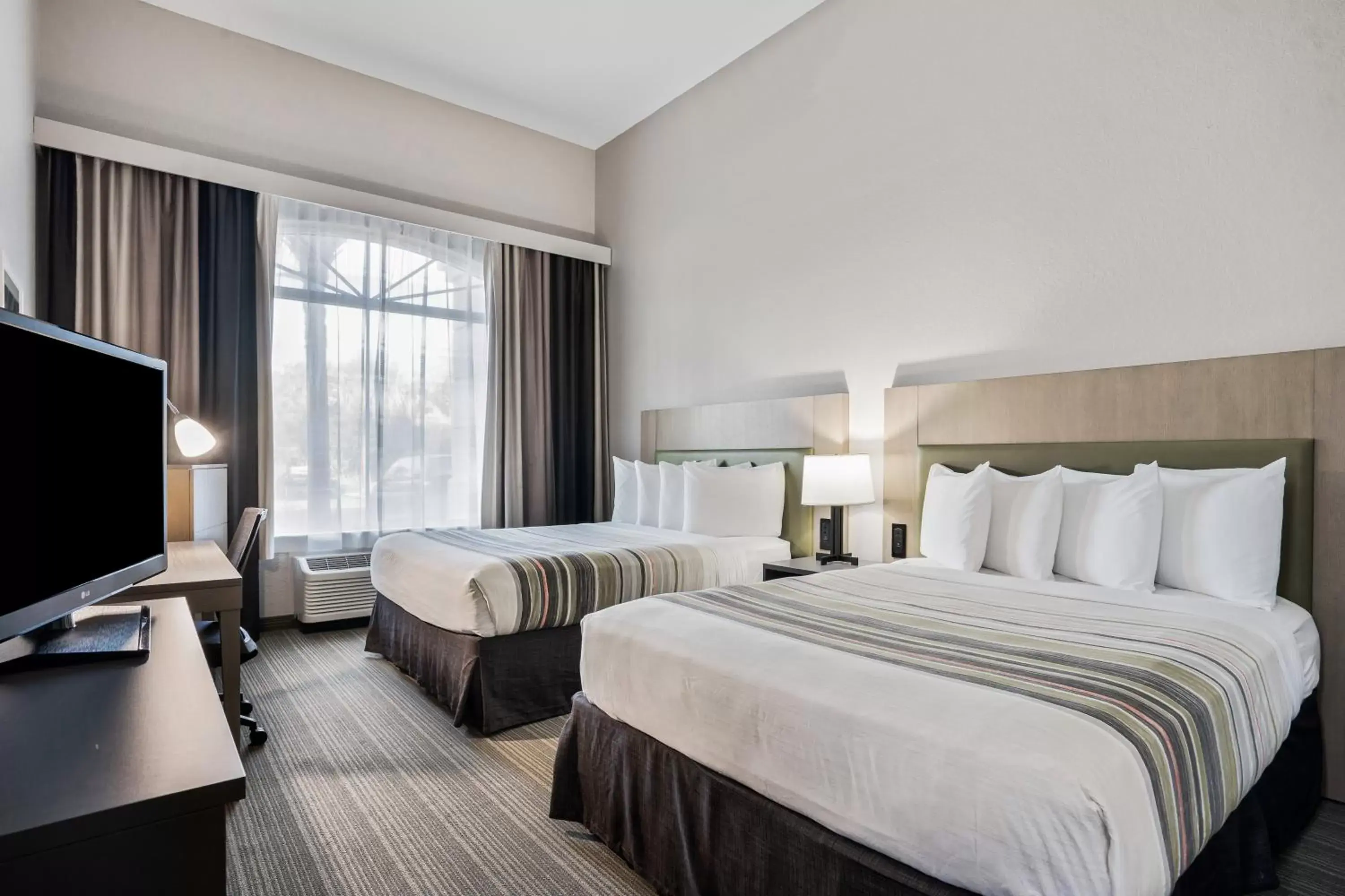 Queen Room with Two Queen Beds in Country Inn & Suites by Radisson, Port Canaveral, FL Queen Room with Two Queen Beds in Country Inn & Suites by Radisson, Port Canaveral, FL