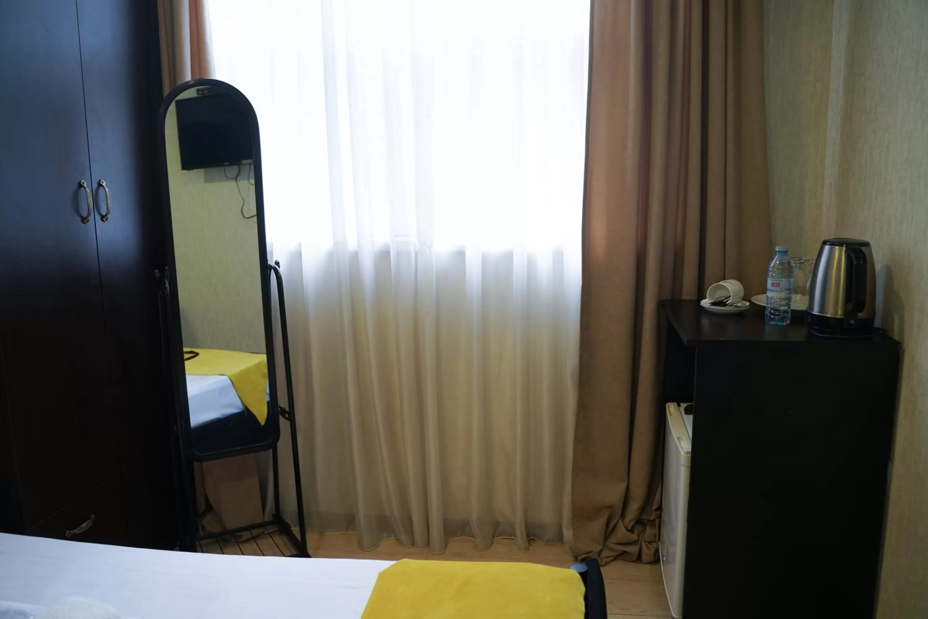 Photo of the whole room, TV/Entertainment Center in Aura Plaza Hotel