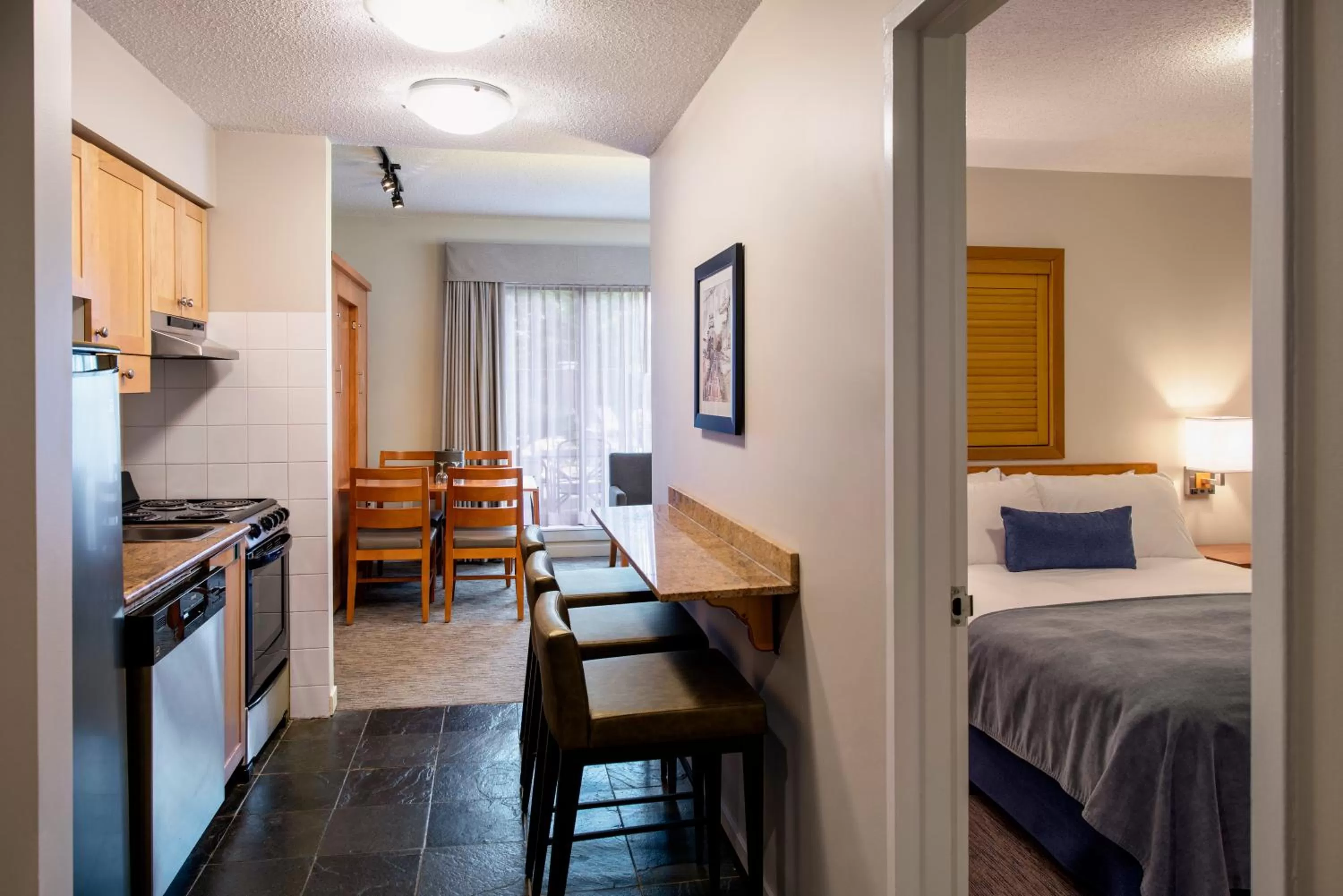 Kitchen or kitchenette, Bed in Whistler Village Inn & Suites