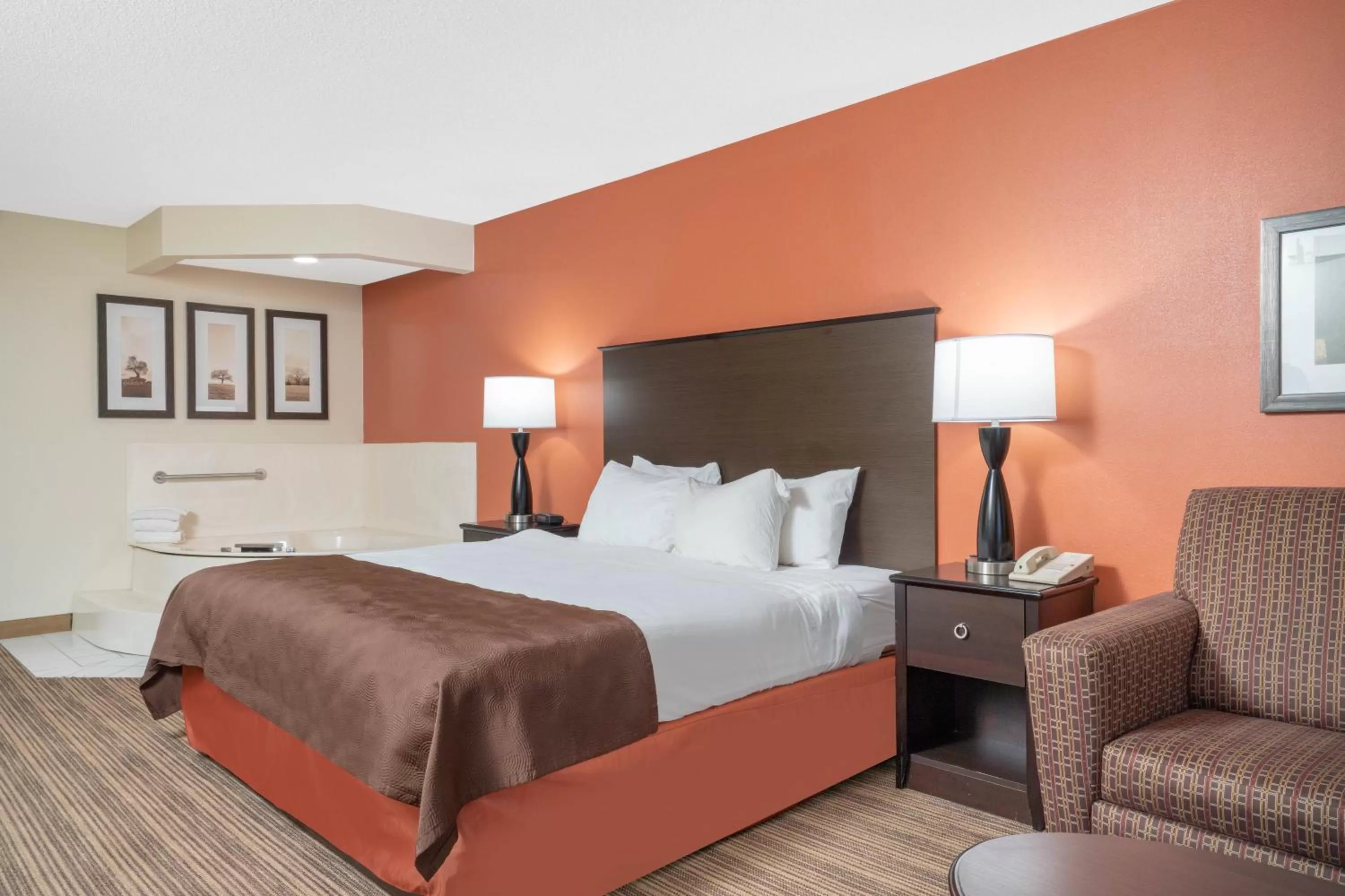 Bed in AmericInn by Wyndham Rogers