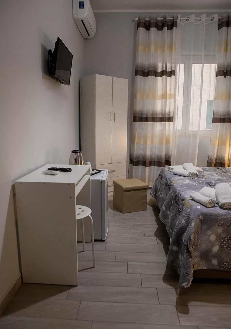 Bed, TV/Entertainment Center in zuroli suite