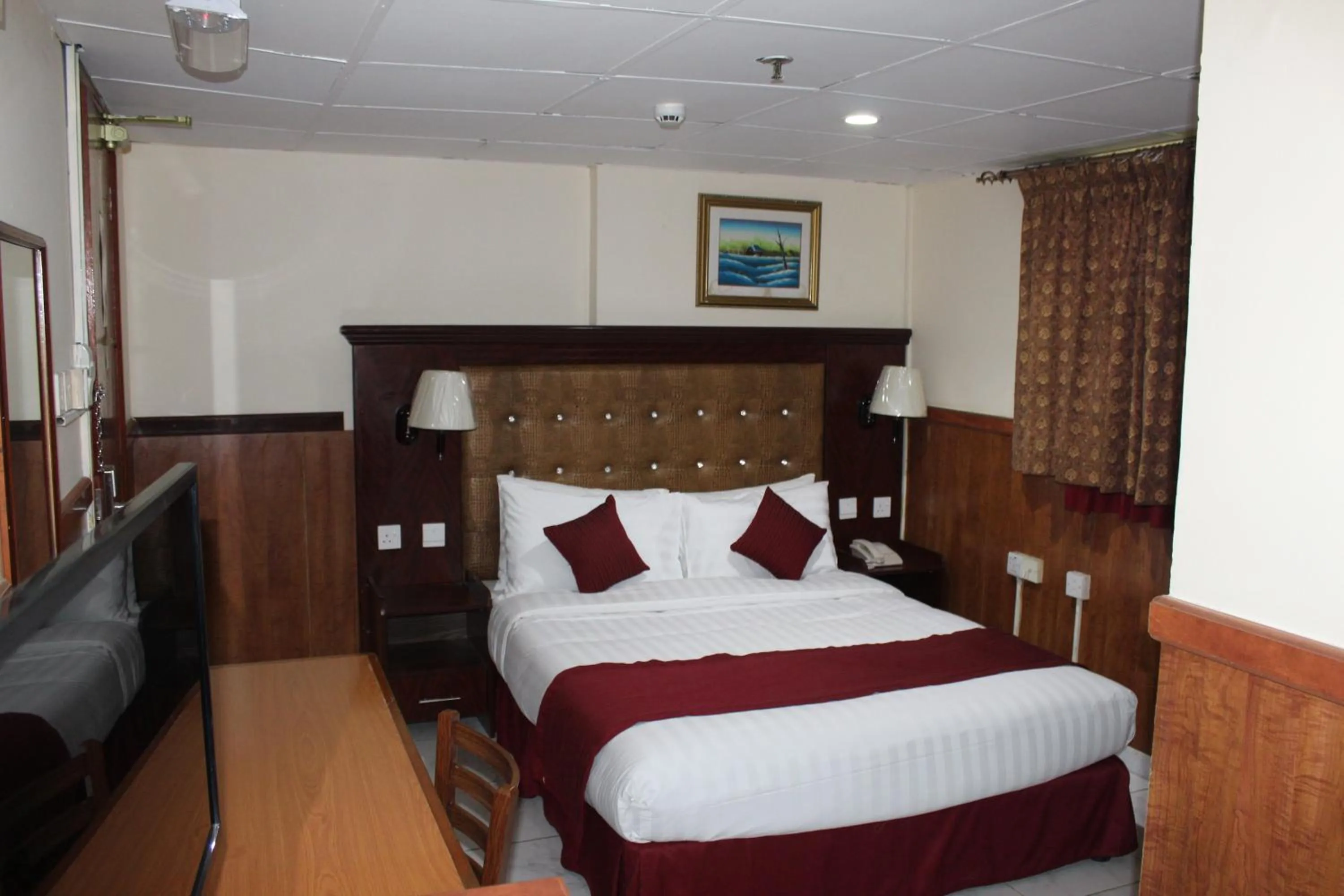 Bed in Grand Nova Hotel