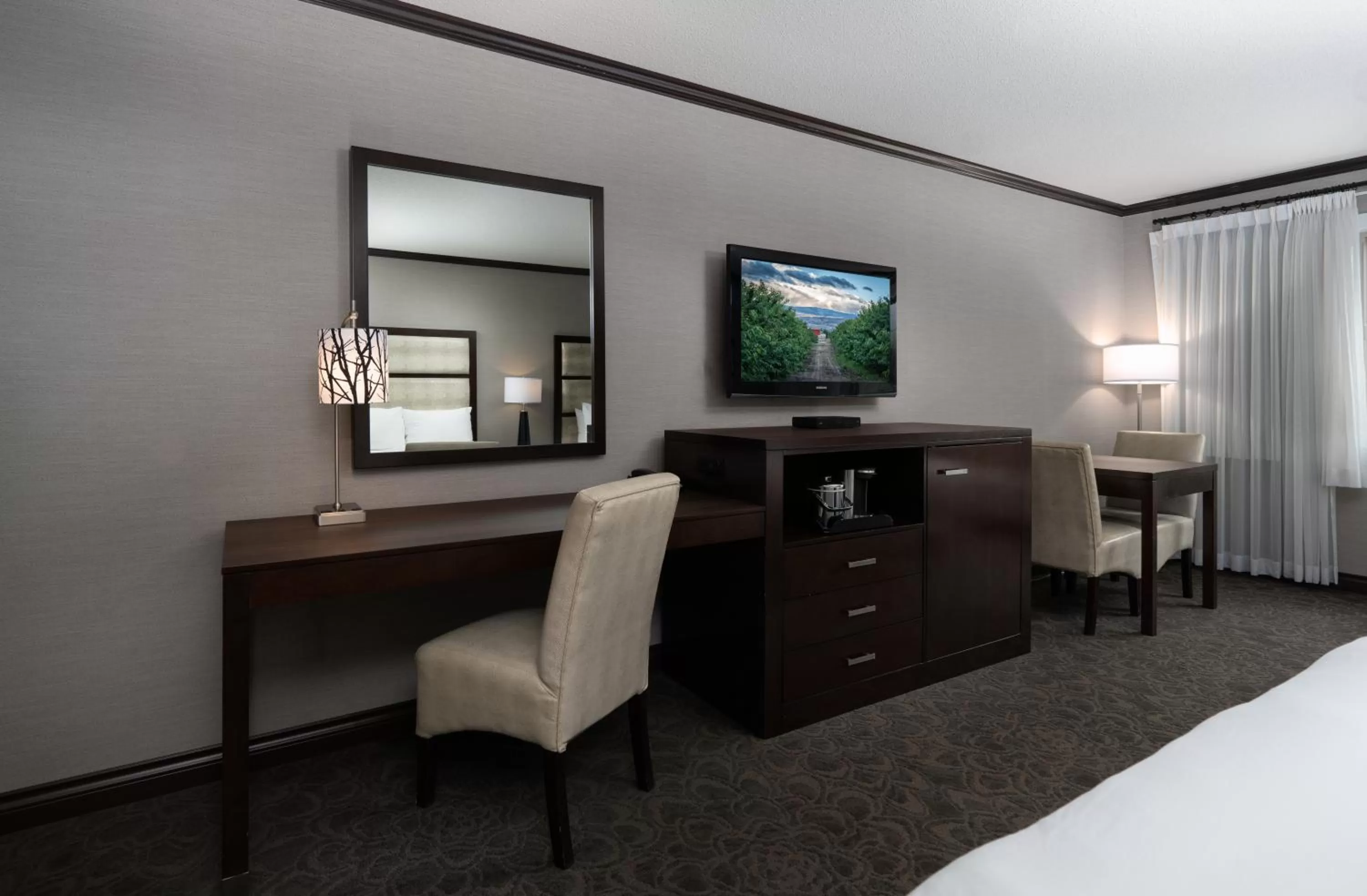 Seating area, Bed in Prestige Vernon Hotel