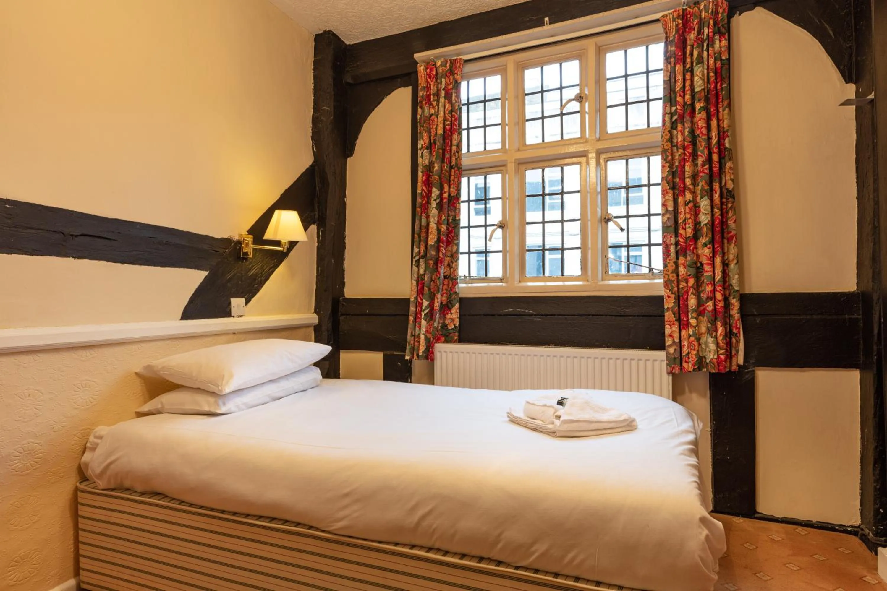 Bed in The New Inn by Roomsbooked