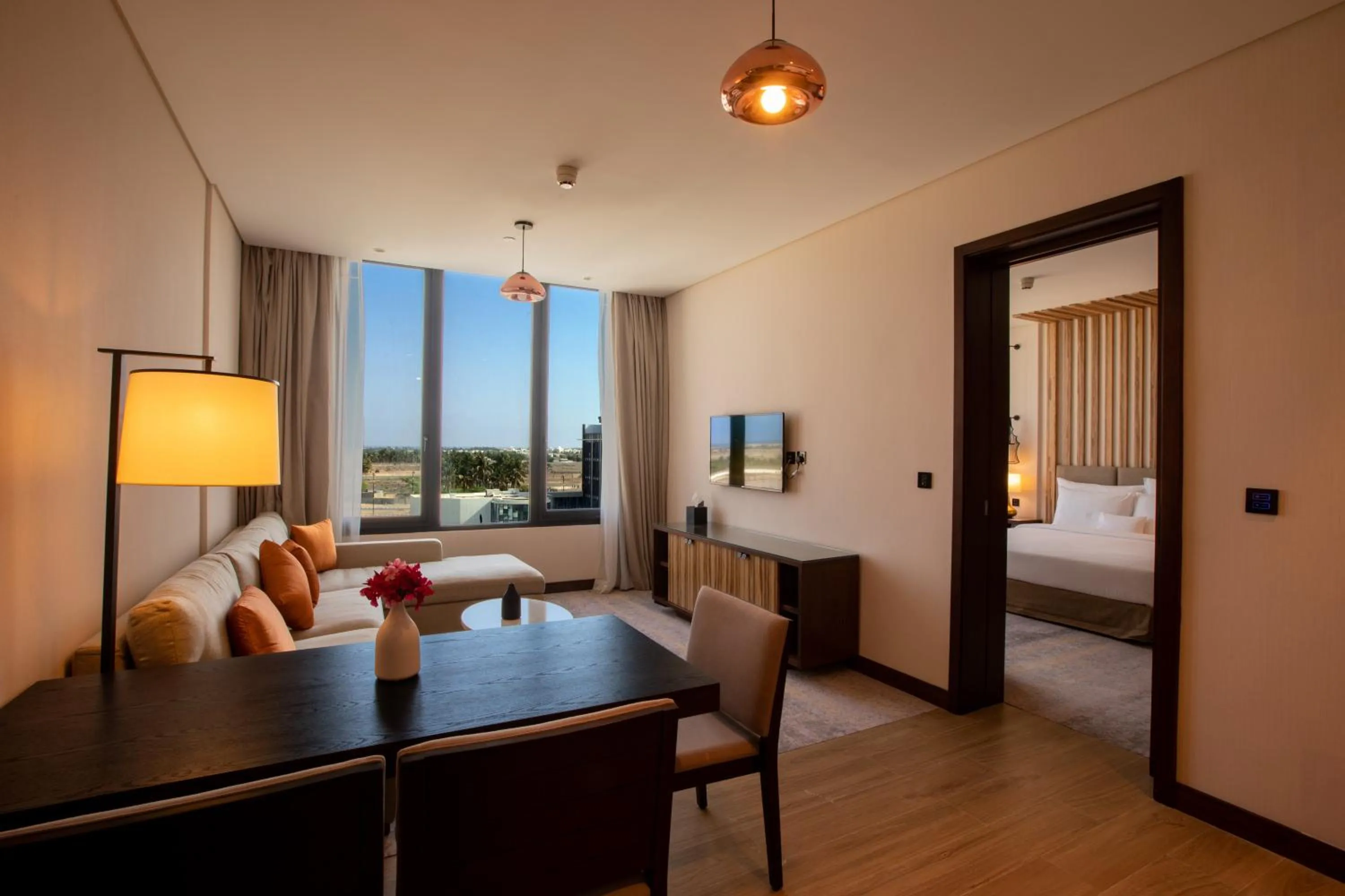 Living room, Bed in Millennium Resort Salalah