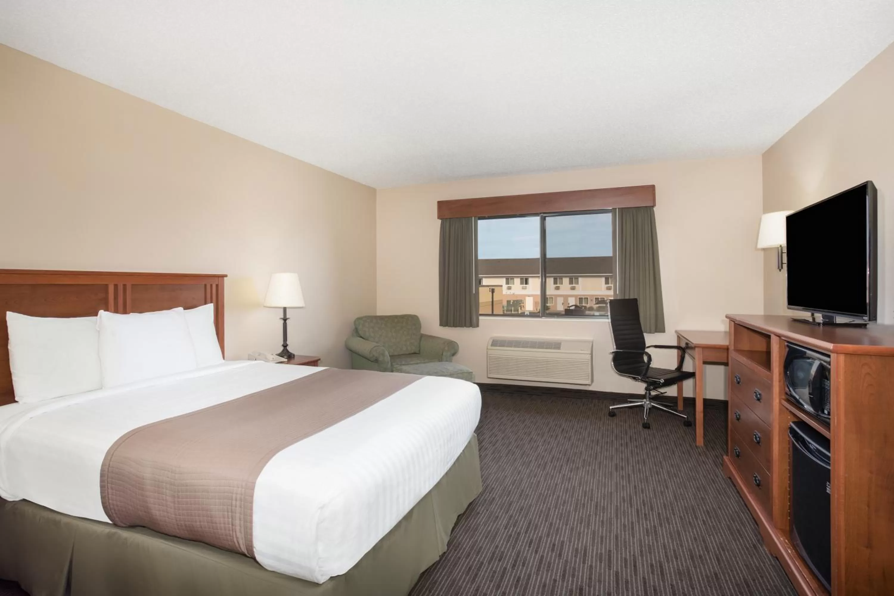 Bed in AmericInn by Wyndham Sioux City