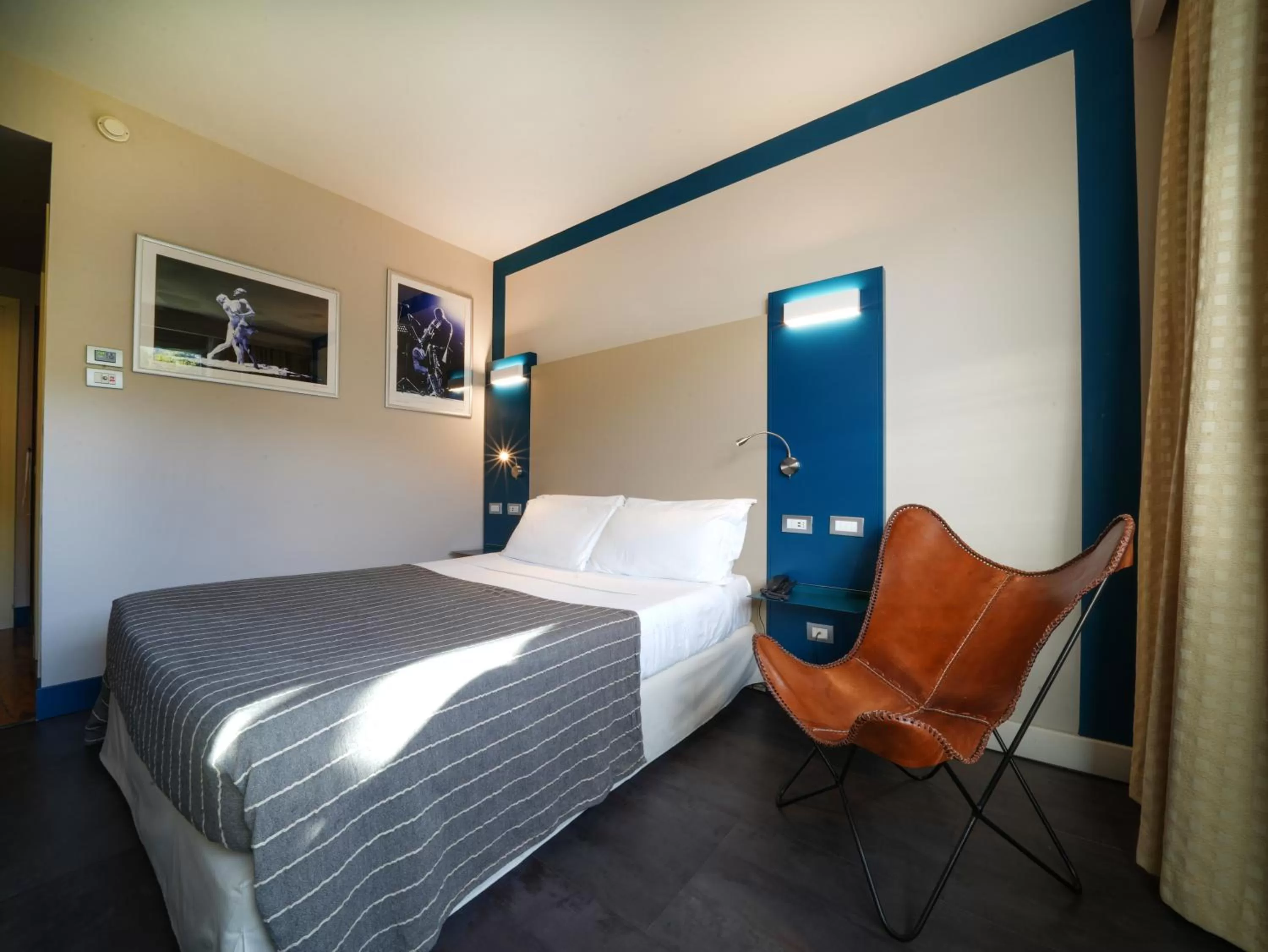 Bed in La Meridiana Bleisure Hotel