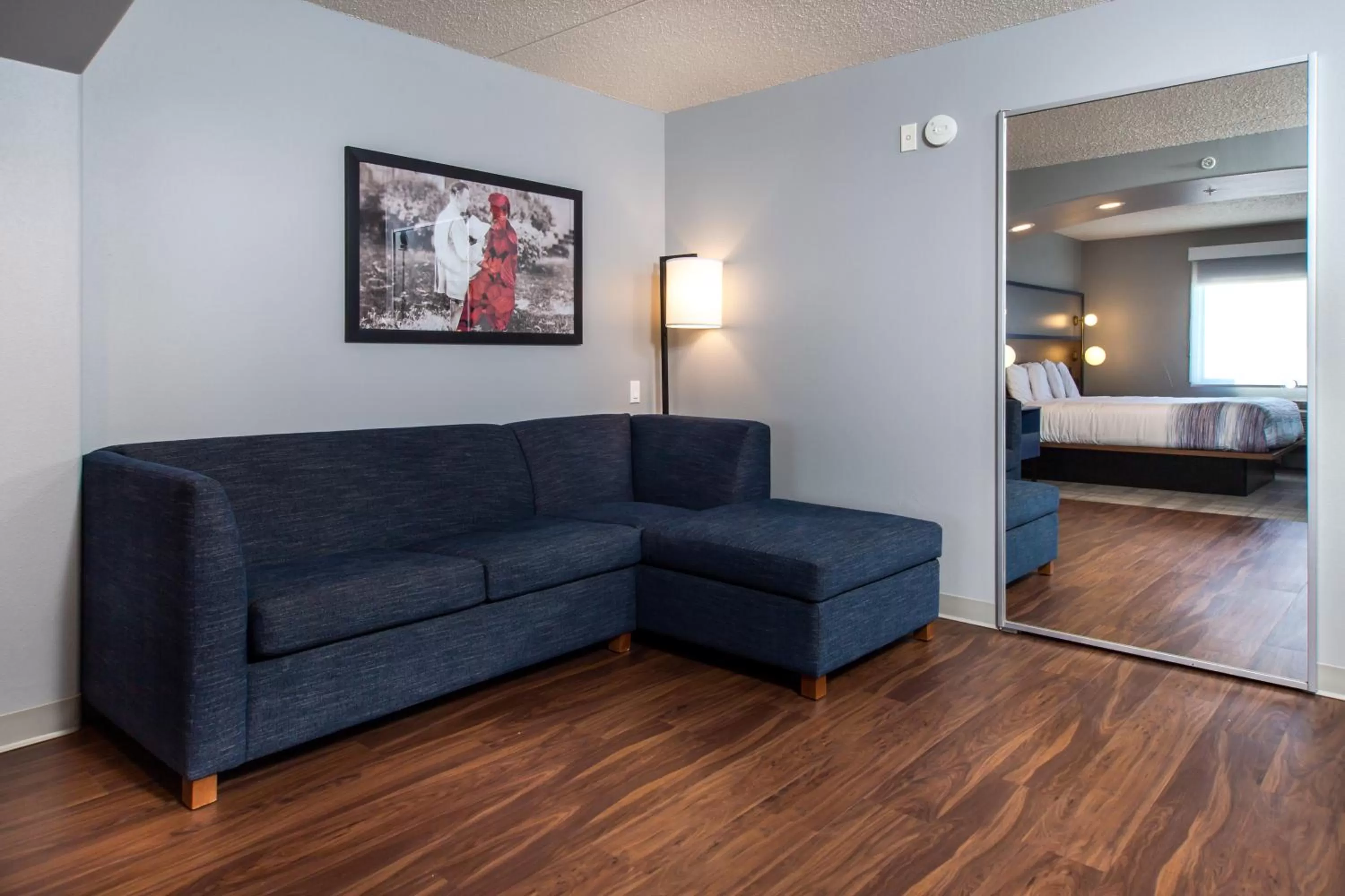 Living room, Bed in AmericInn by Wyndham Rapid City