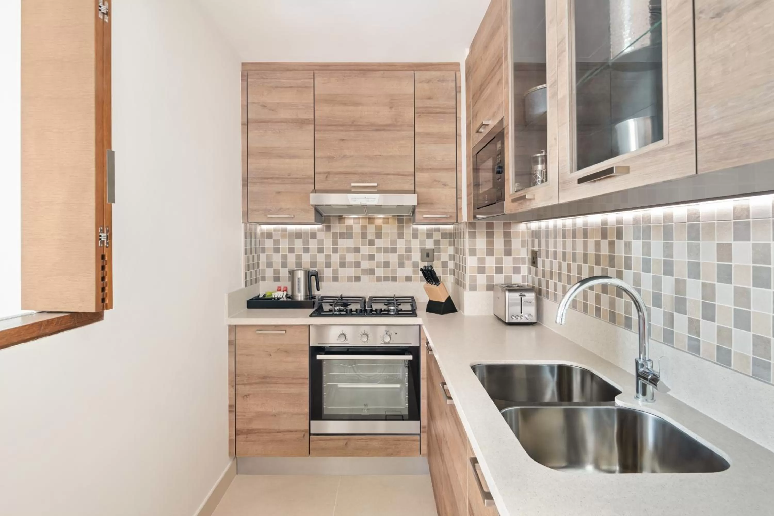 Kitchen or kitchenette in Staybridge Suites Dubai Al-Maktoum Airport by IHG