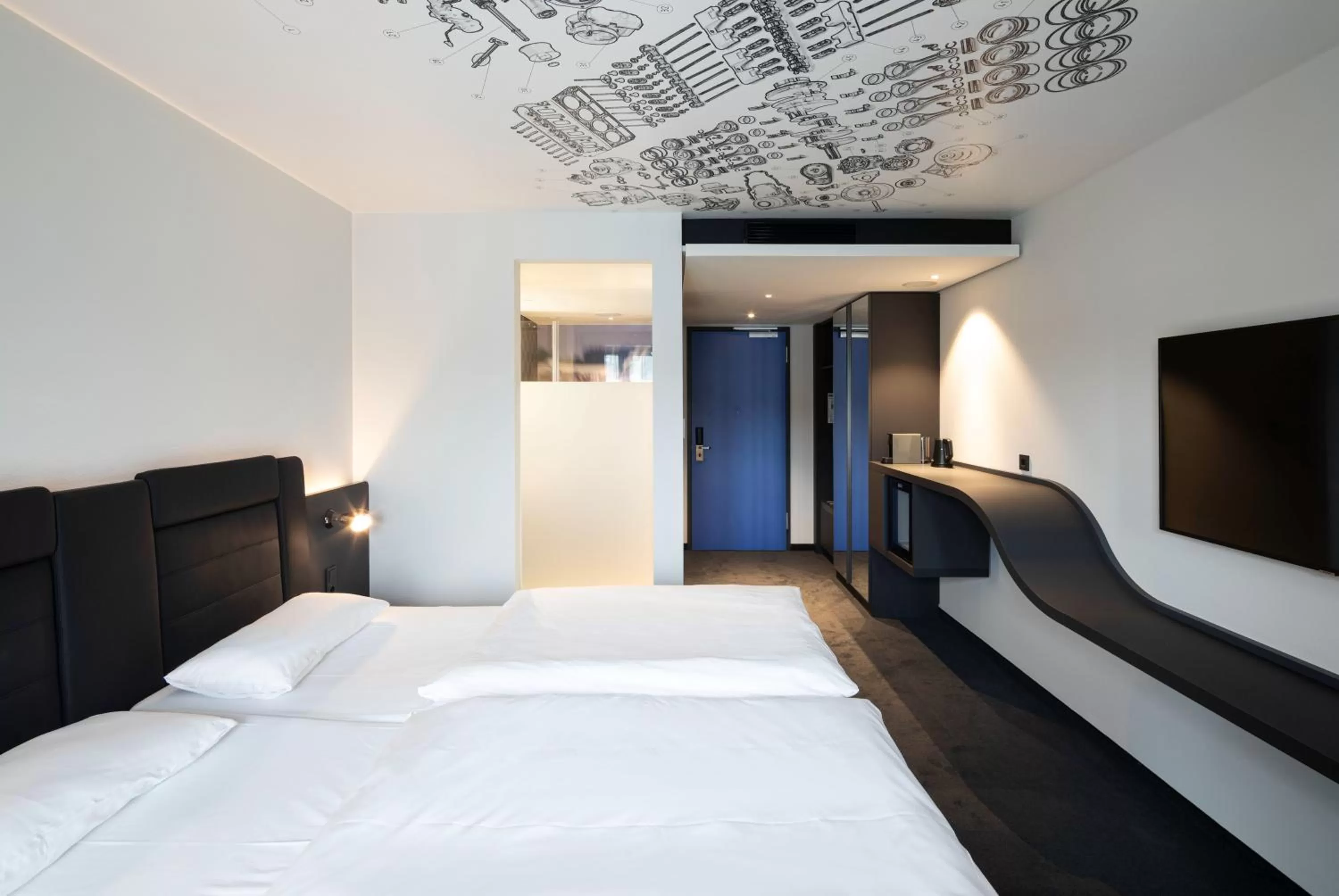 Photo of the whole room, Bed in V8 Hotel Köln at MOTORWORLD