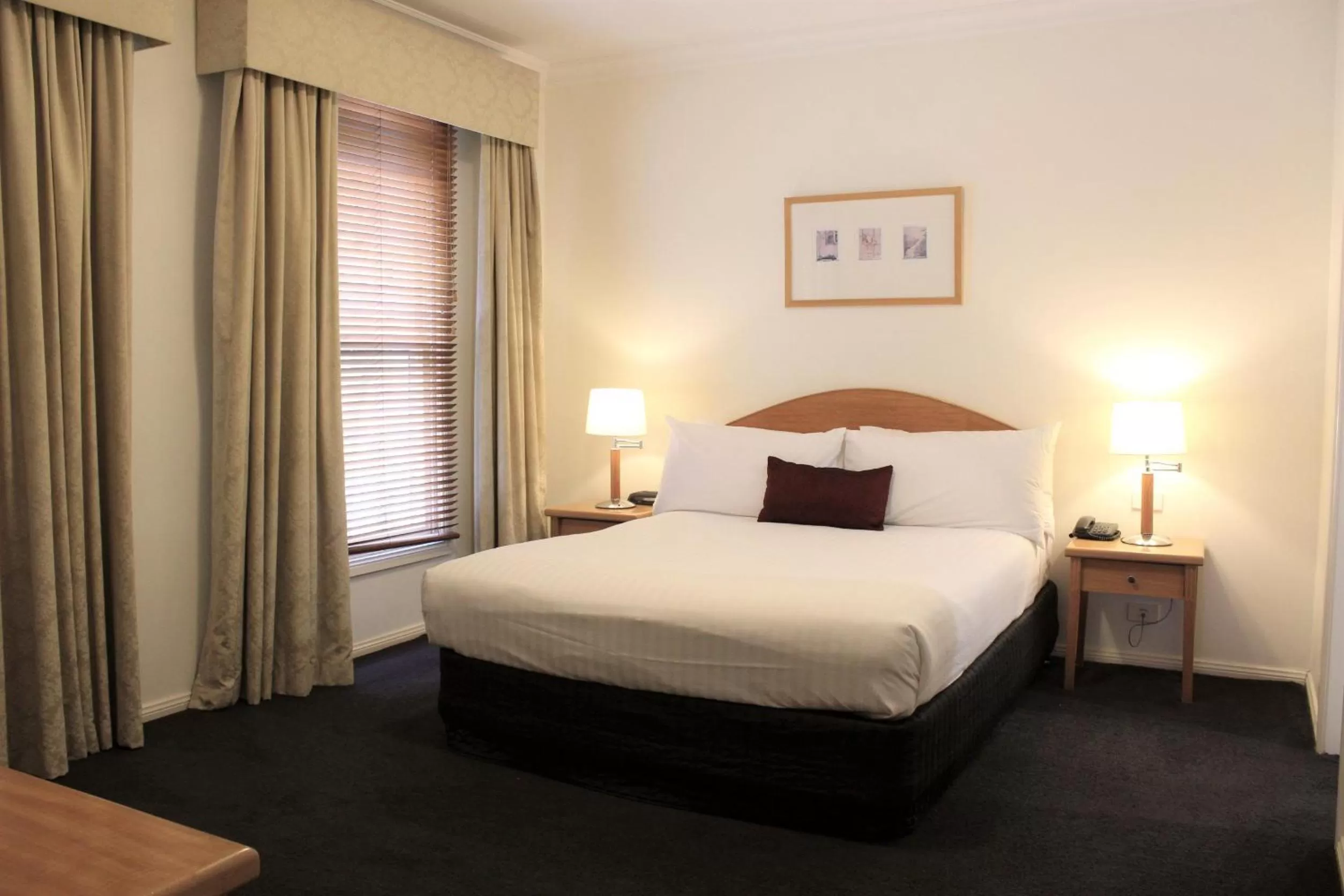 Bed in Carlyle Suites & Apartments