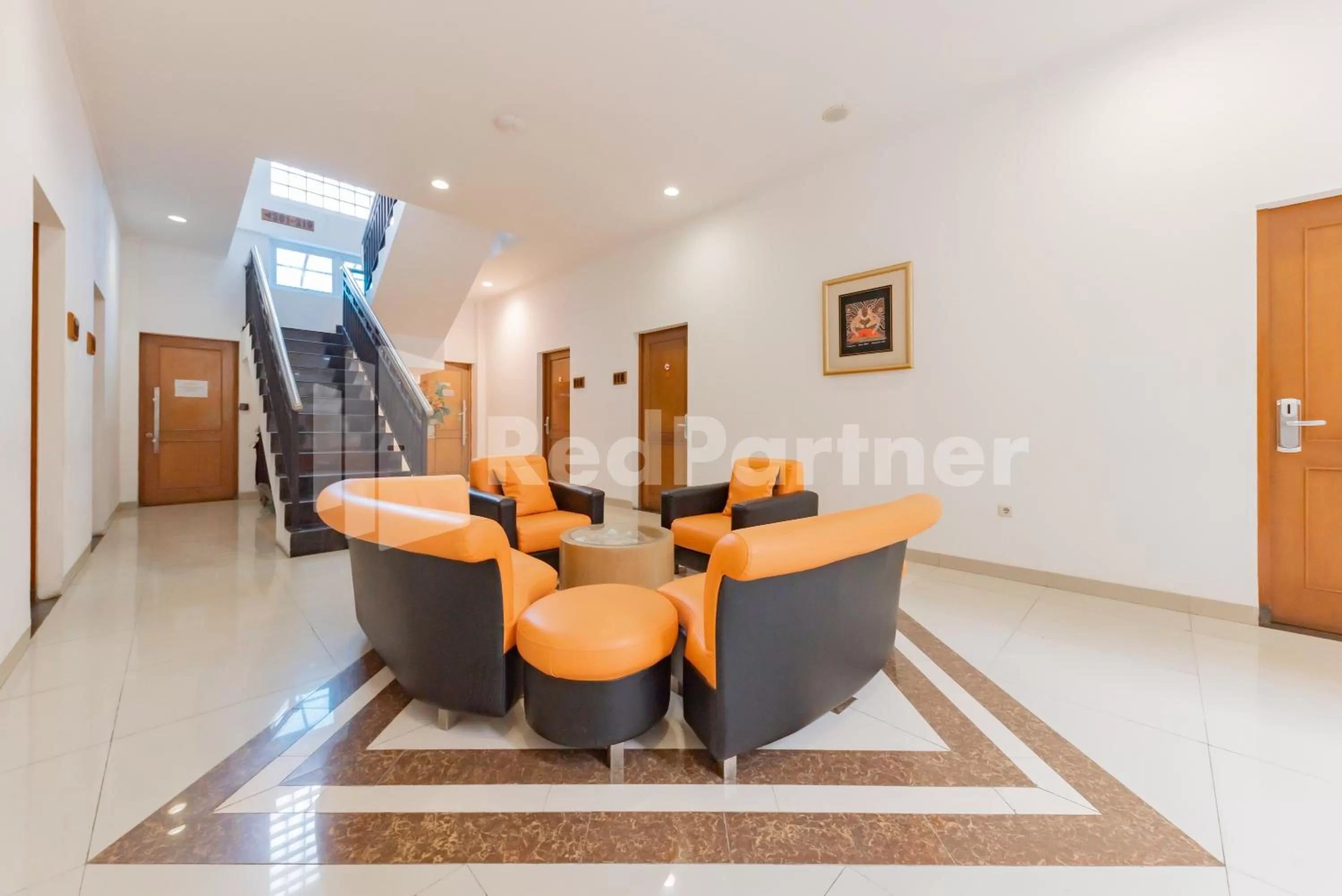 Living room in Alqueby Hotel near Kiara Artha Park & Trans Studio Mall Mitra RedDoorz