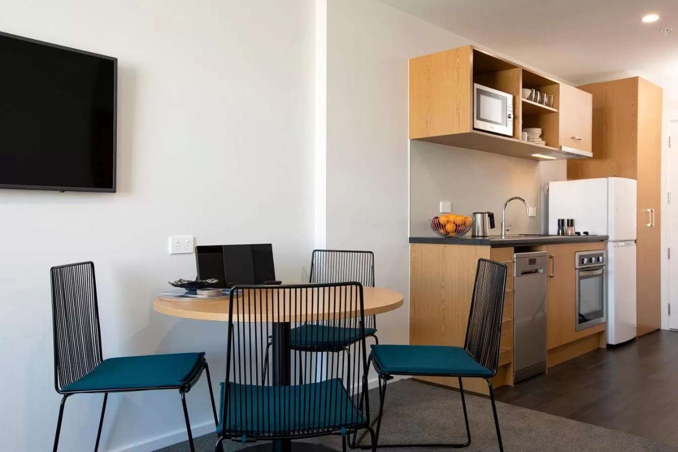 Dining area, TV/Entertainment Center in Quest Tauranga Central