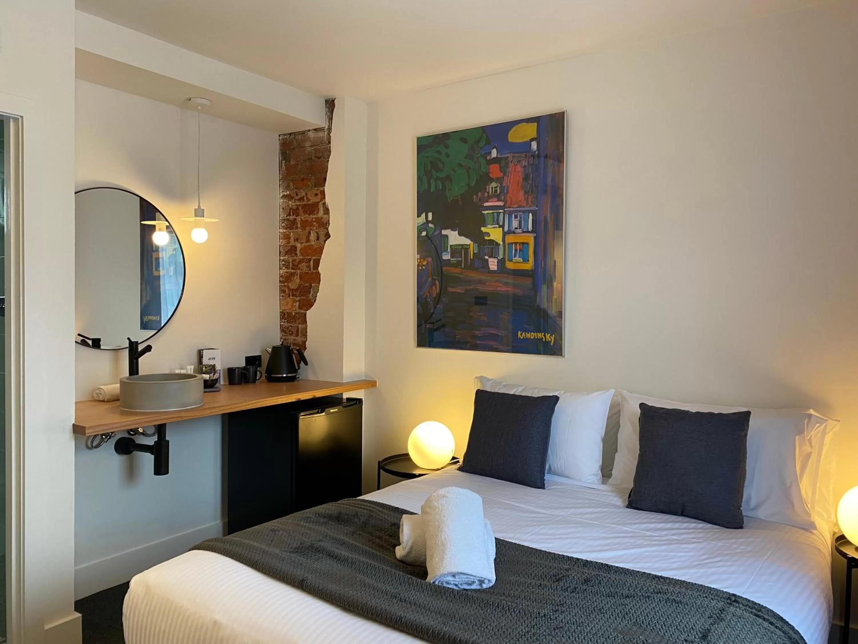 Bed in The Astor Hotel Motel