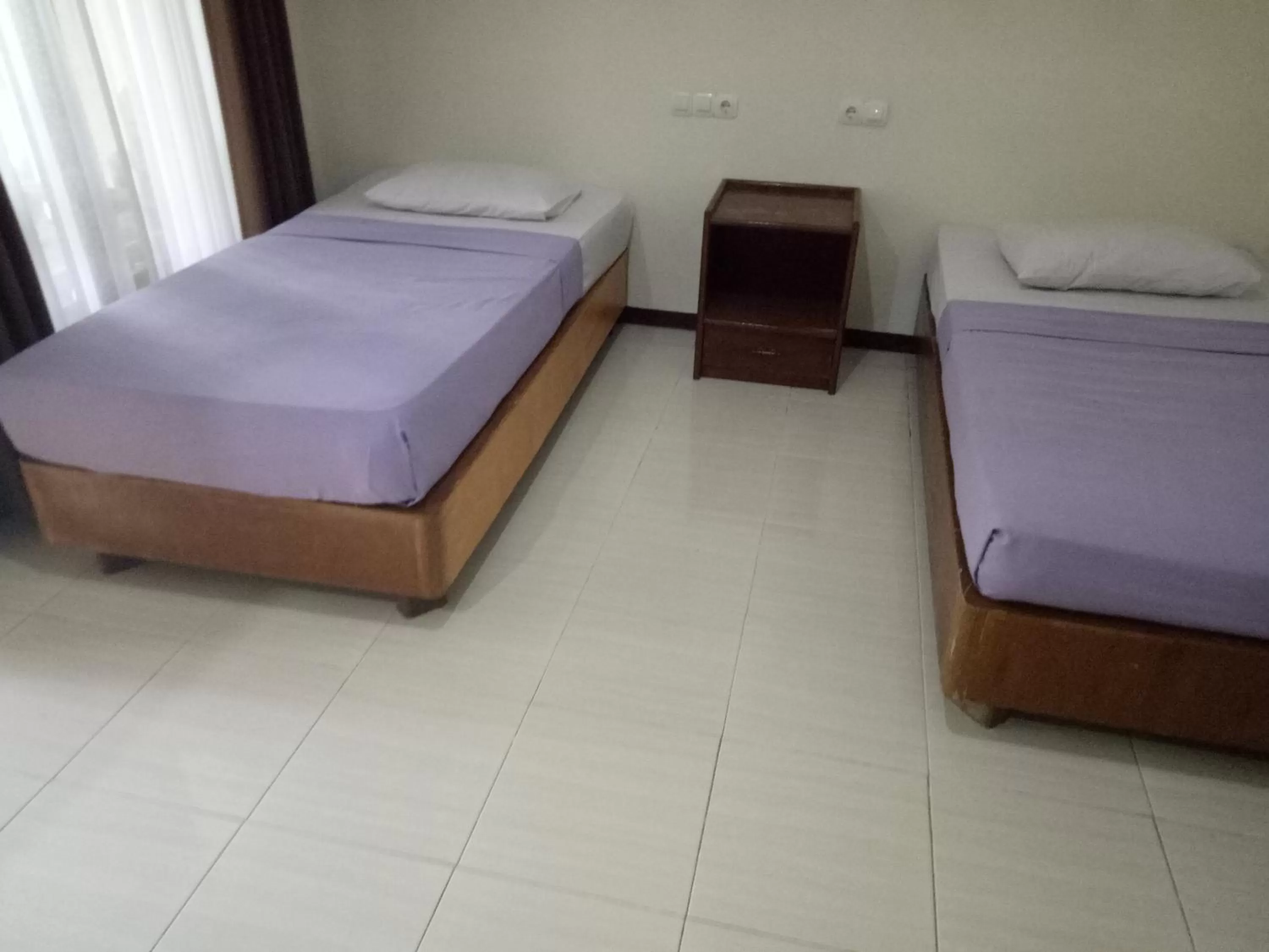 Bed in Astina Hotel