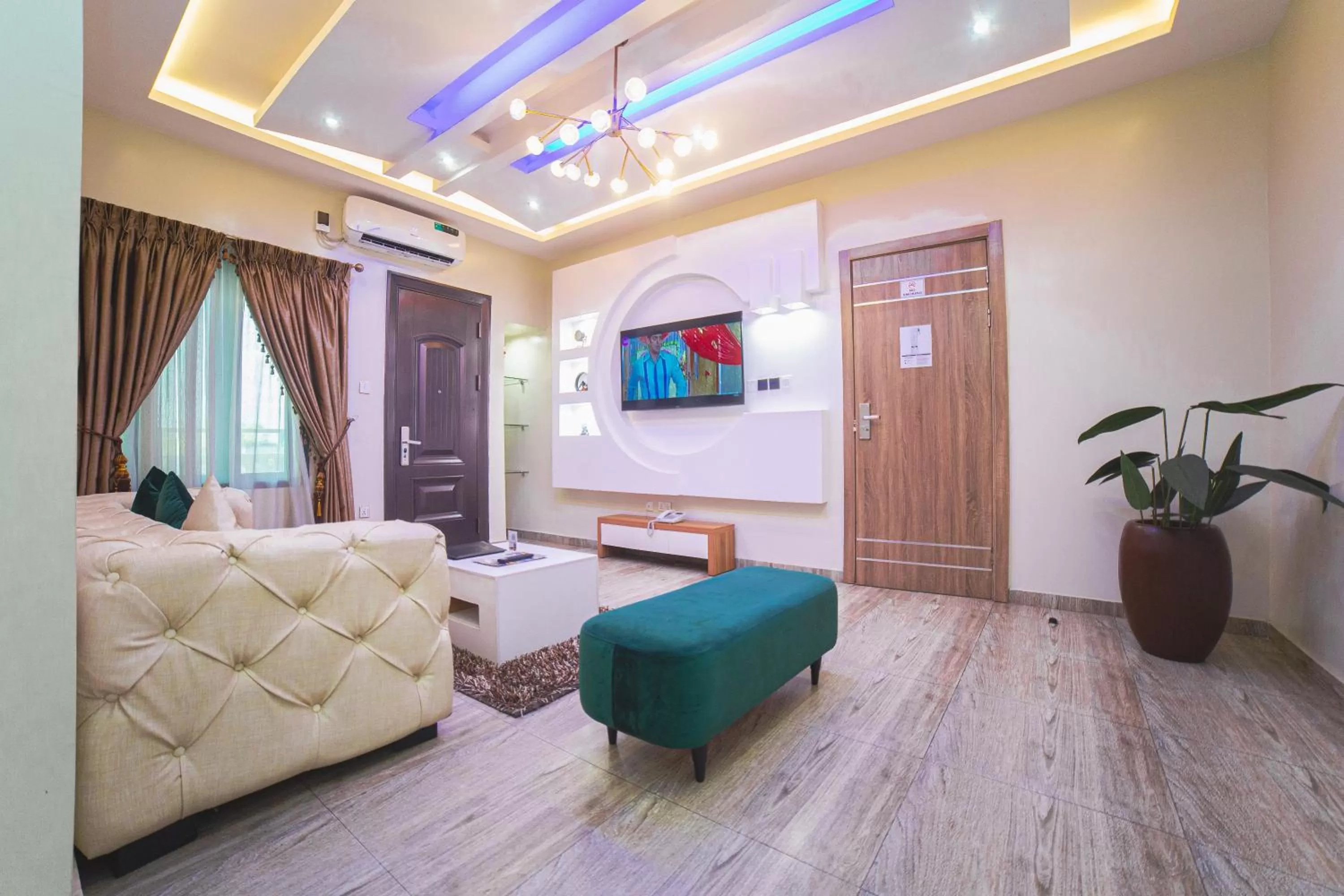 Living room, Bed in God's Touch Apartments Signature