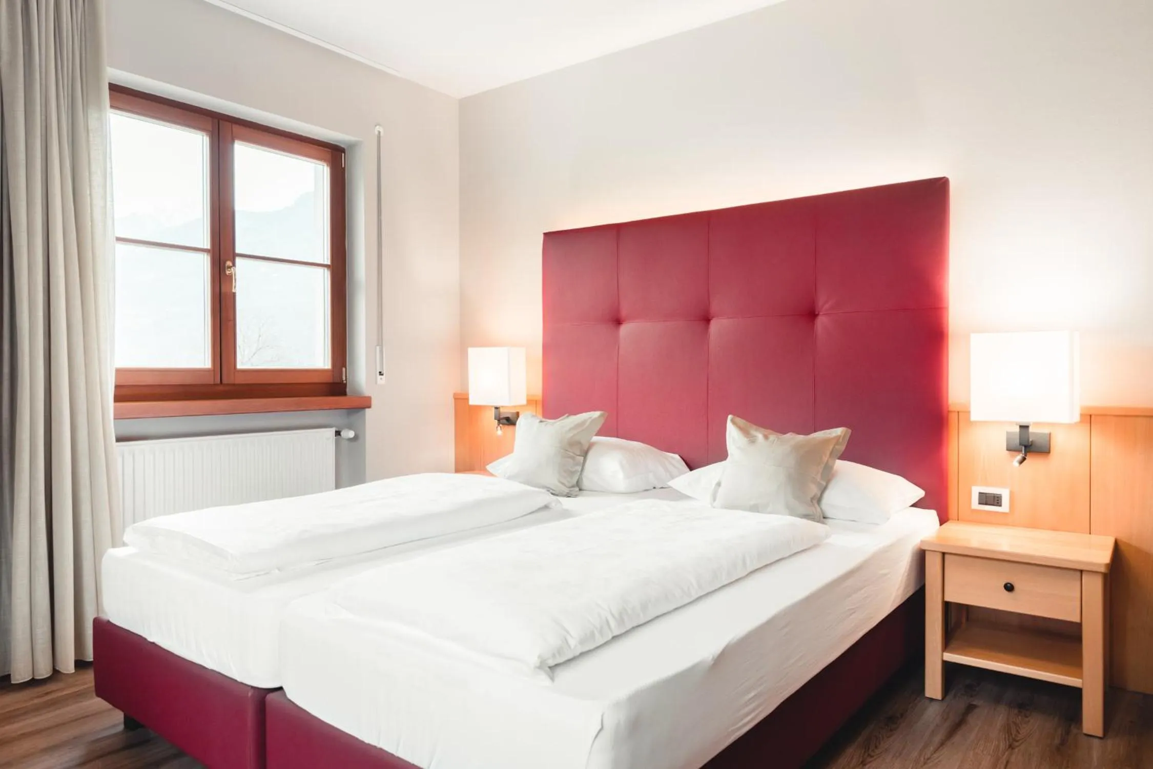 Bed in Hotel Tiefenbrunn Gardensuites & Breakfast