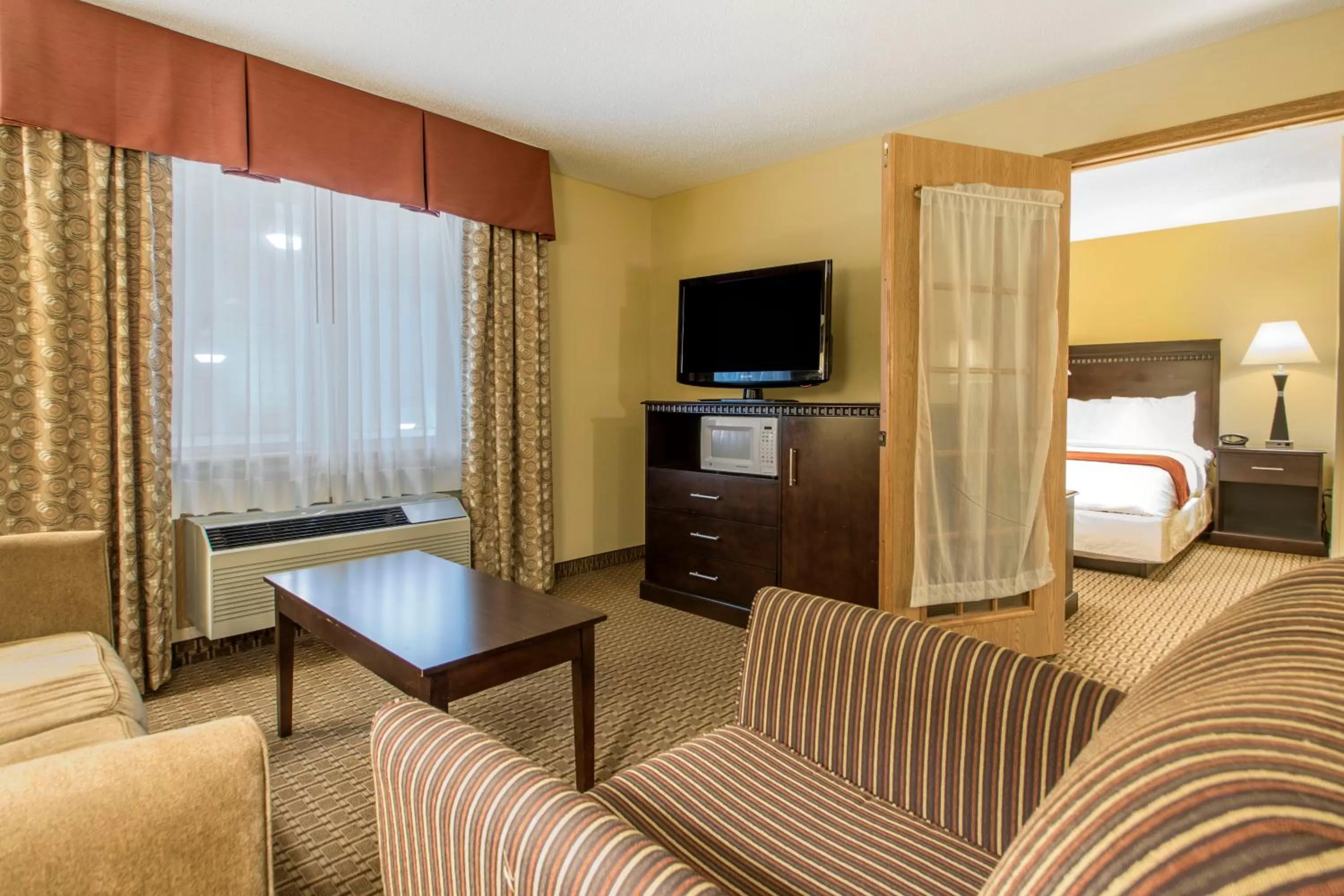 Communal lounge/ TV room, Bed in Comfort Suites Wisconsin Dells Area