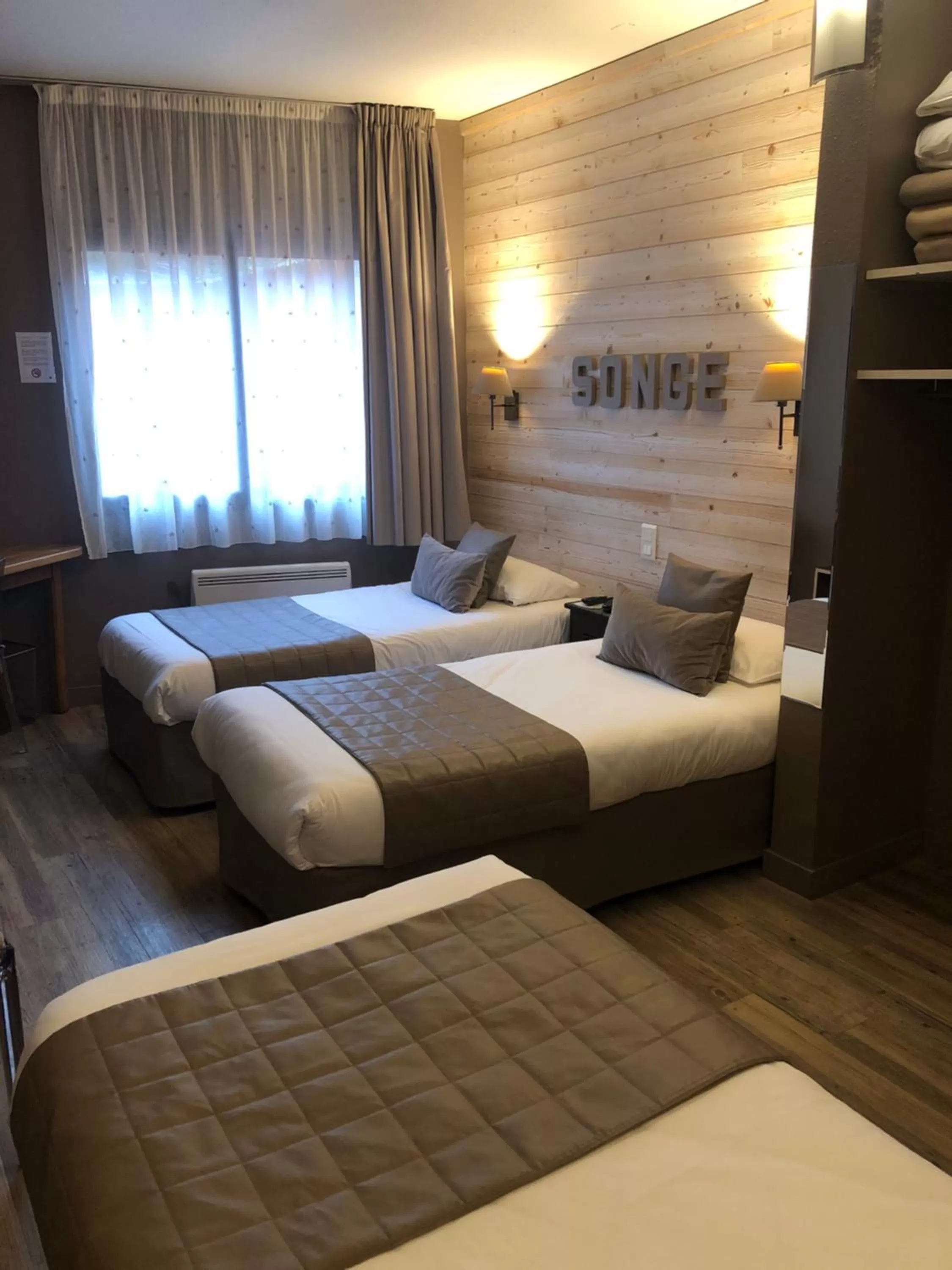 Bed in Logis Hôtel Burnichon