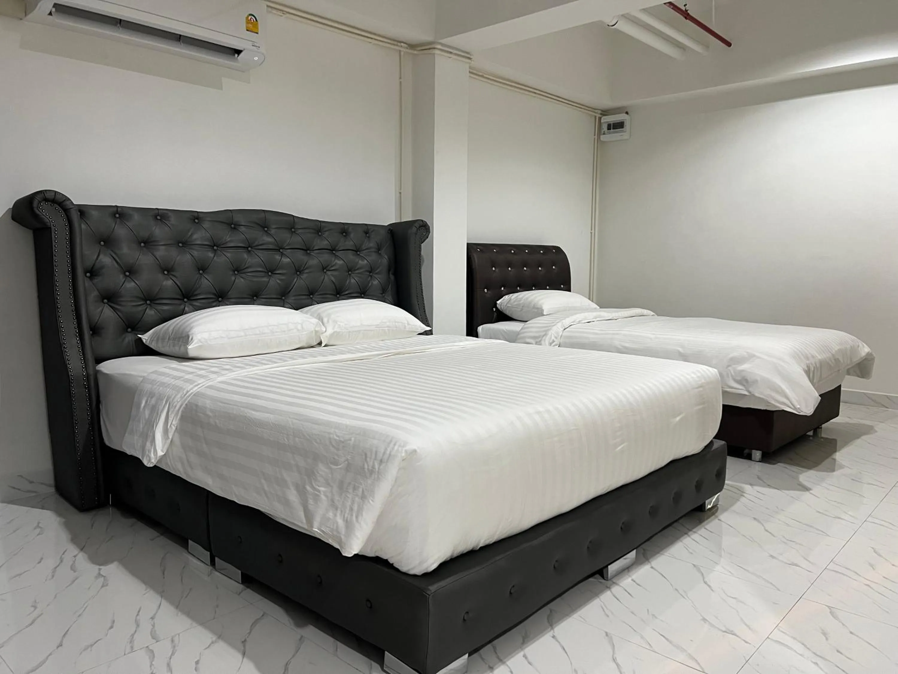 Bed in Mall Suites Hotel