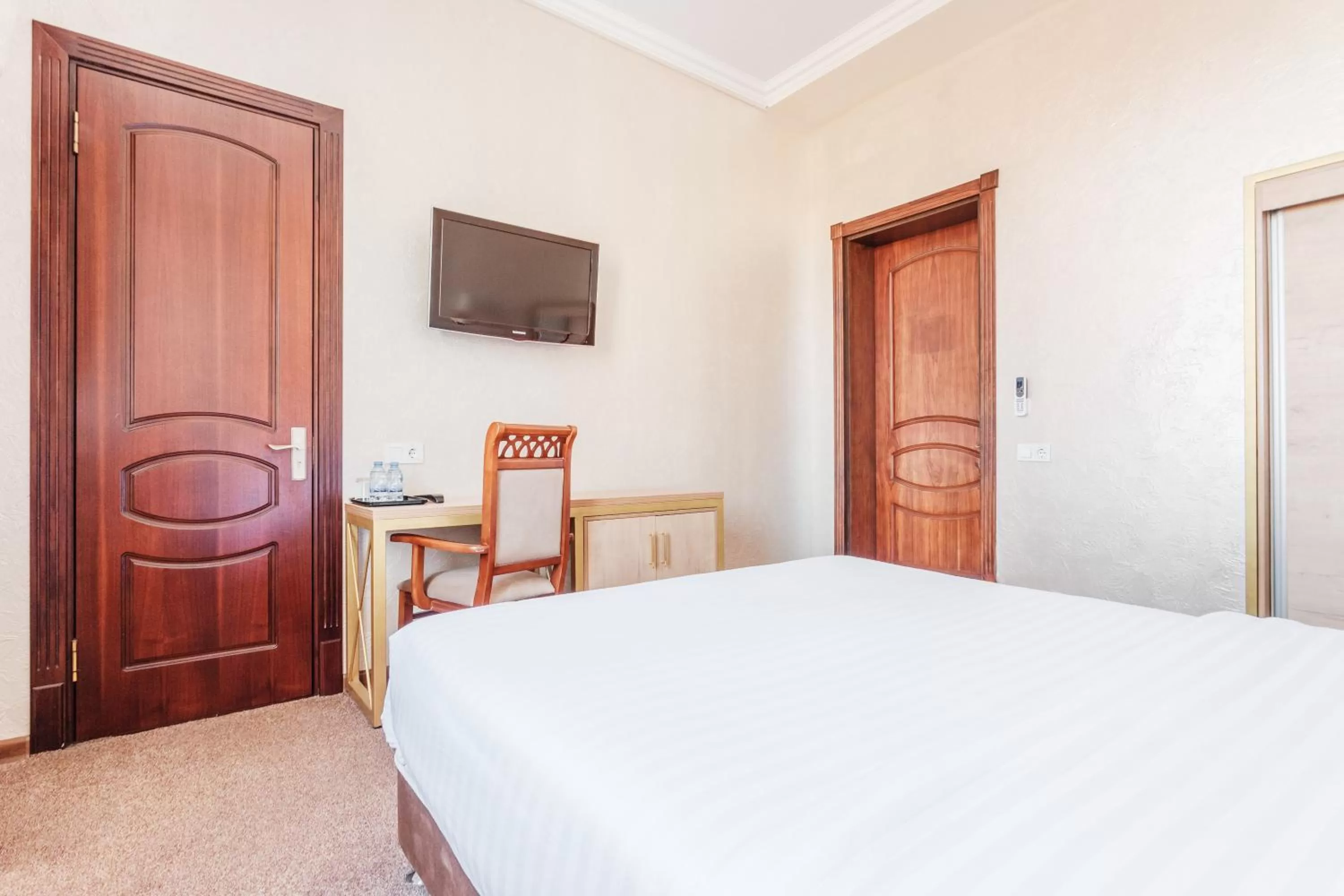 Bed in Western Suites Hotel